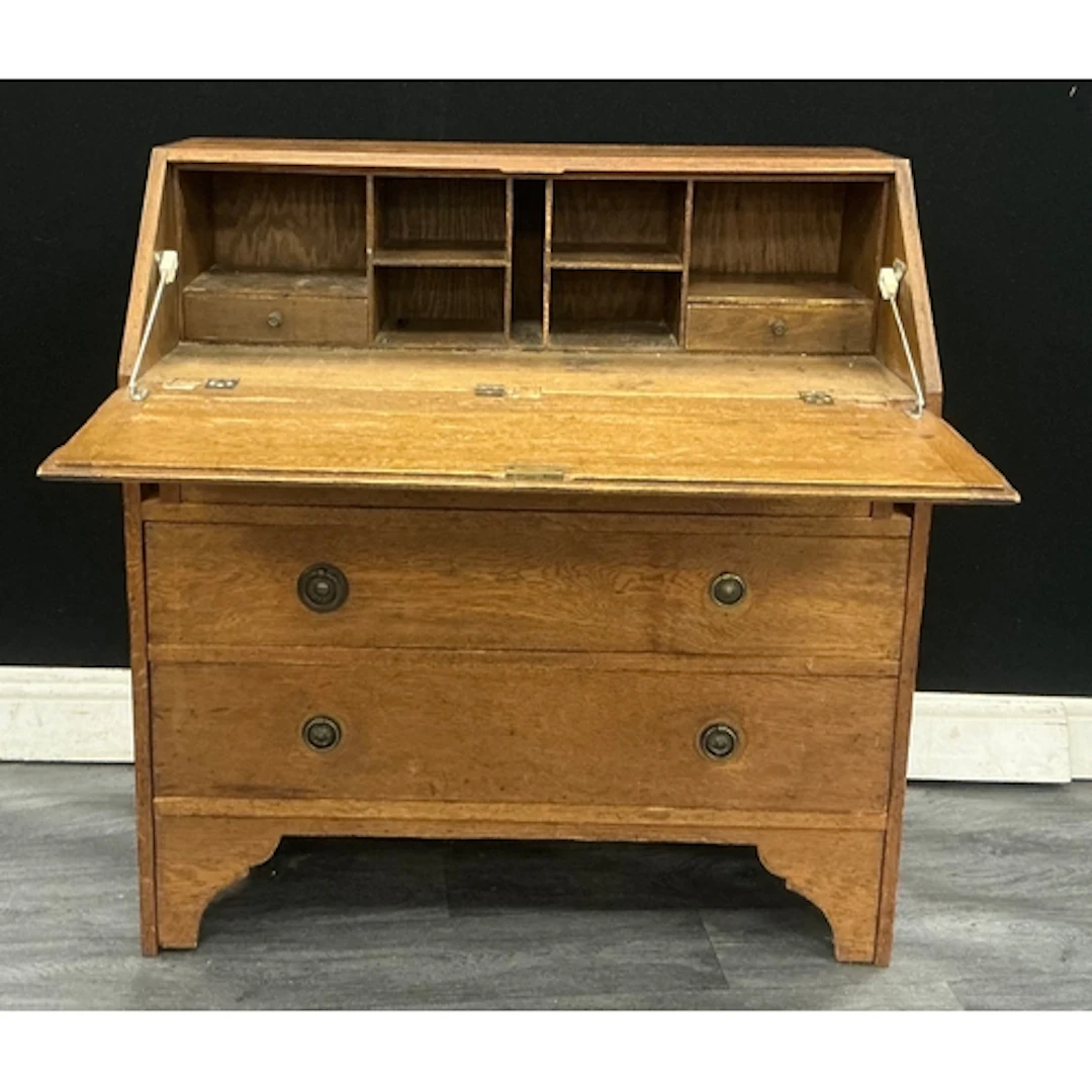 A 20th century oak fall front Bureau opening up to enclosing...