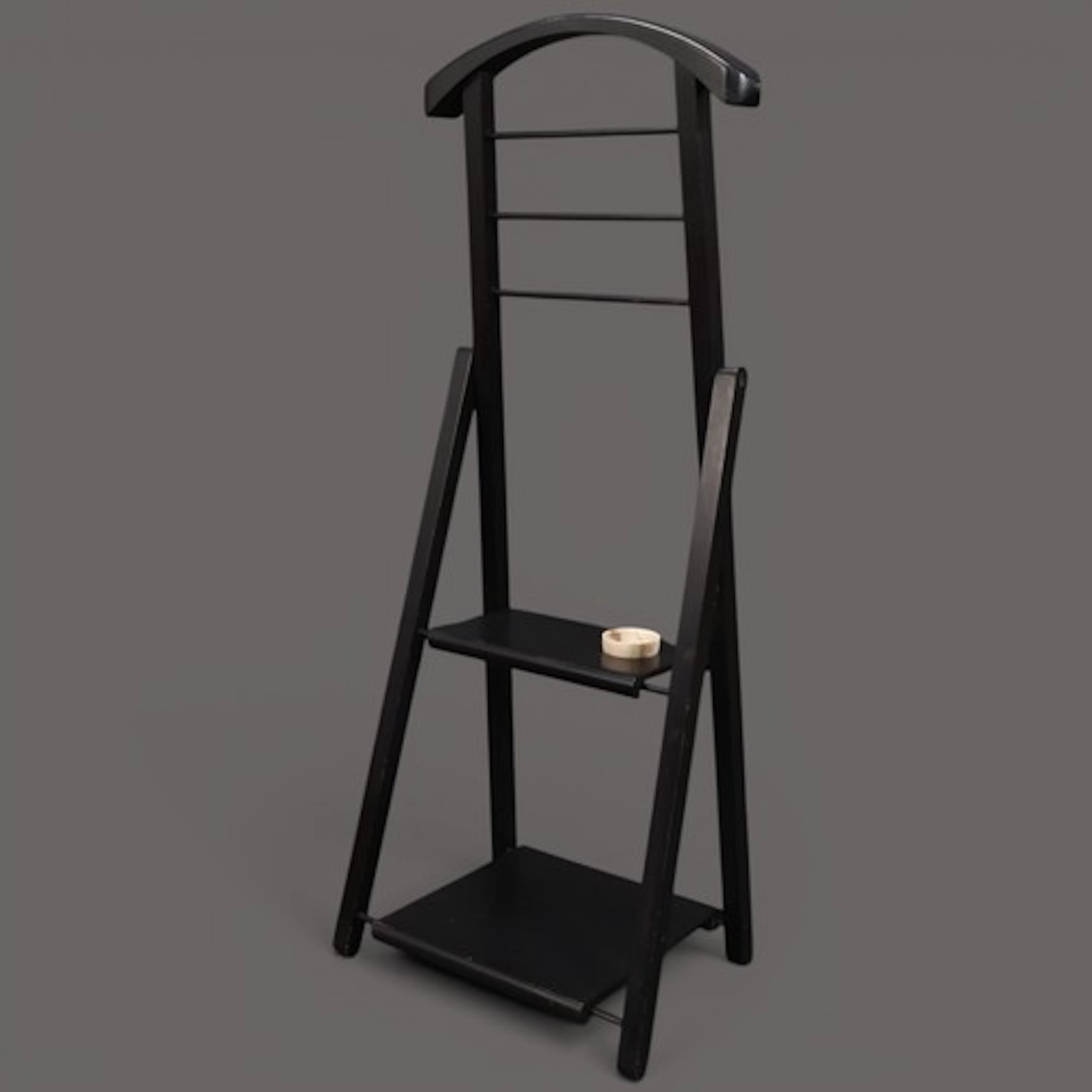 A Vintage black wooden Jeeves clothes valet stand designed b...