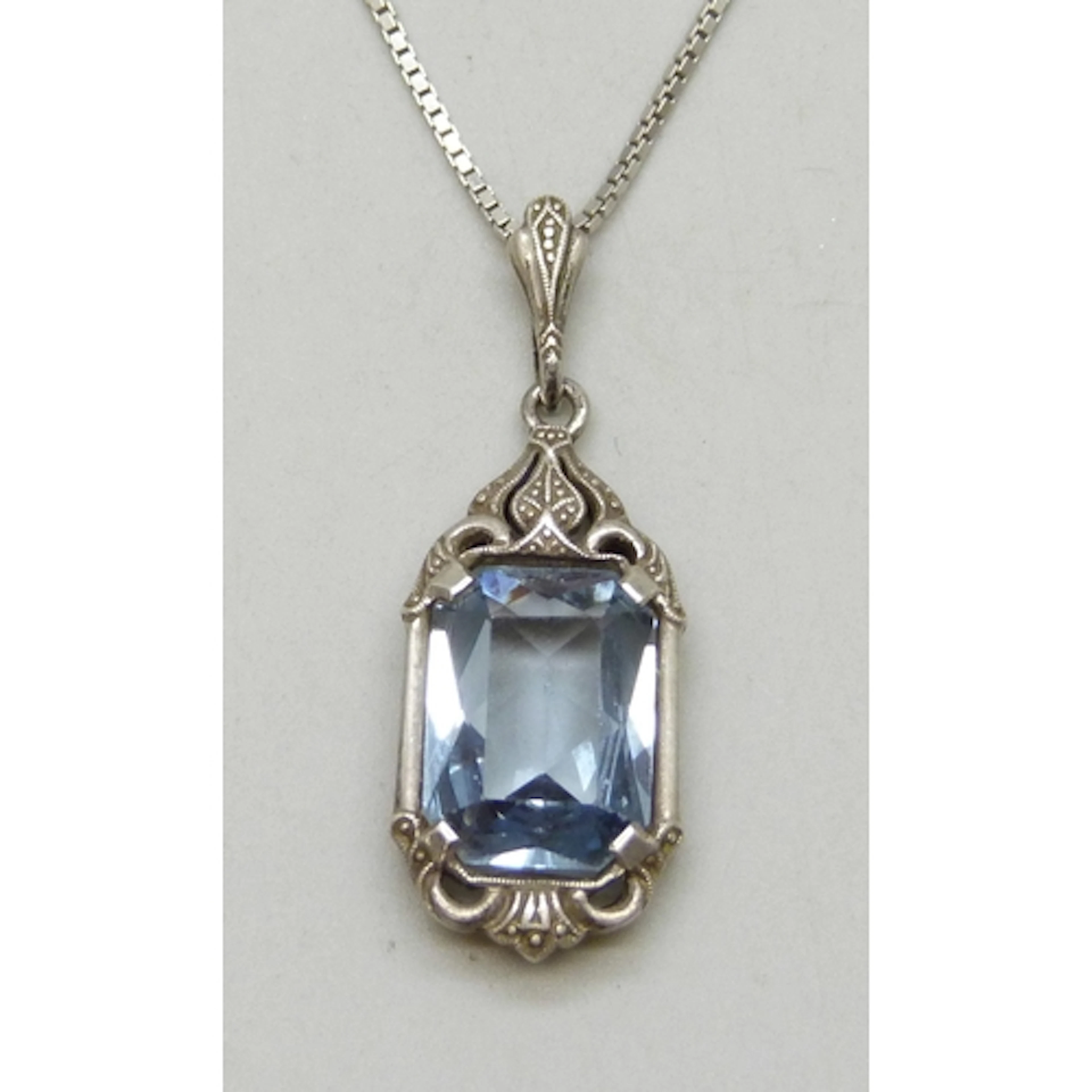 An Art Deco Continental .835 silver pendant set with a topaz...