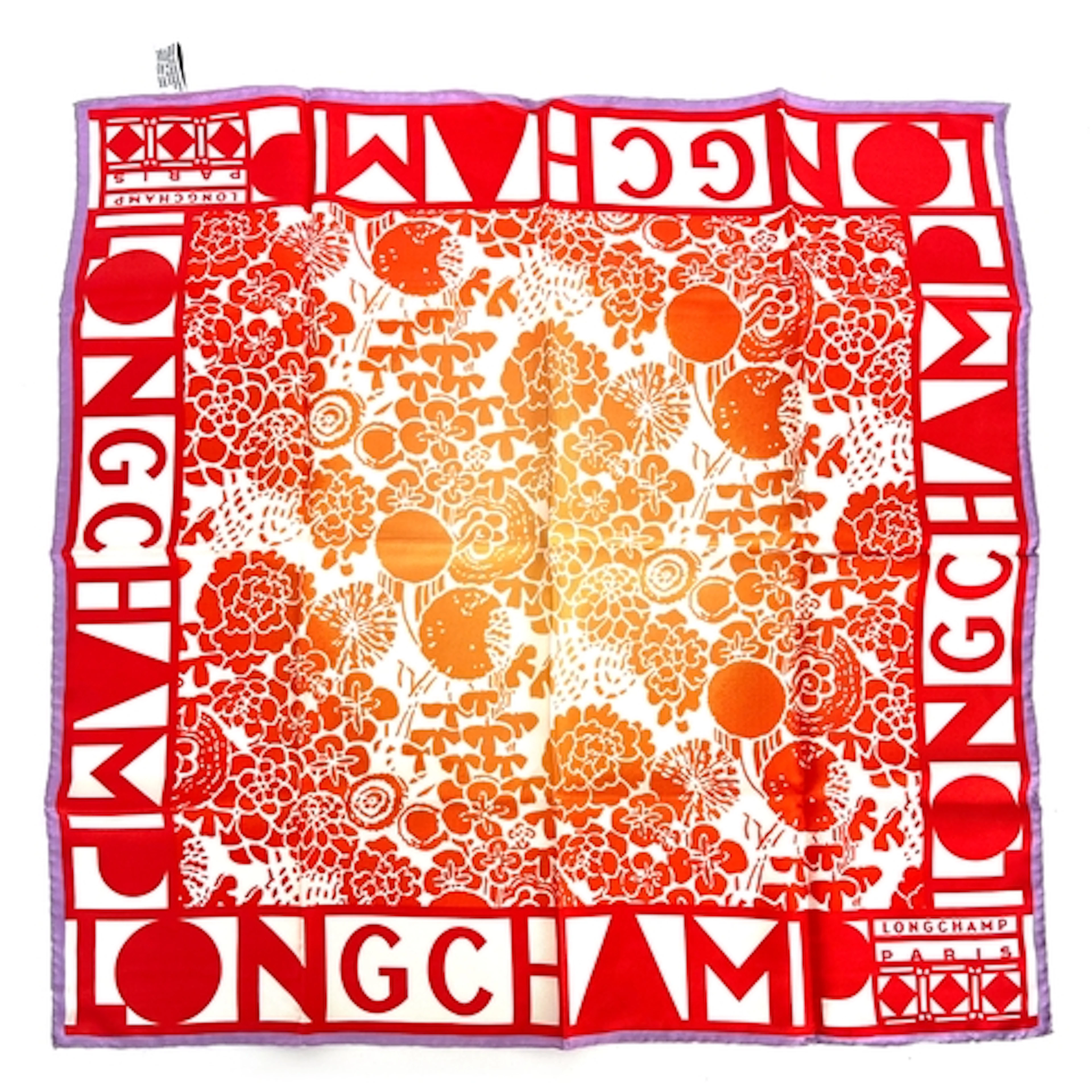 A Longchamp silk scarf in a red and orange floral print with...