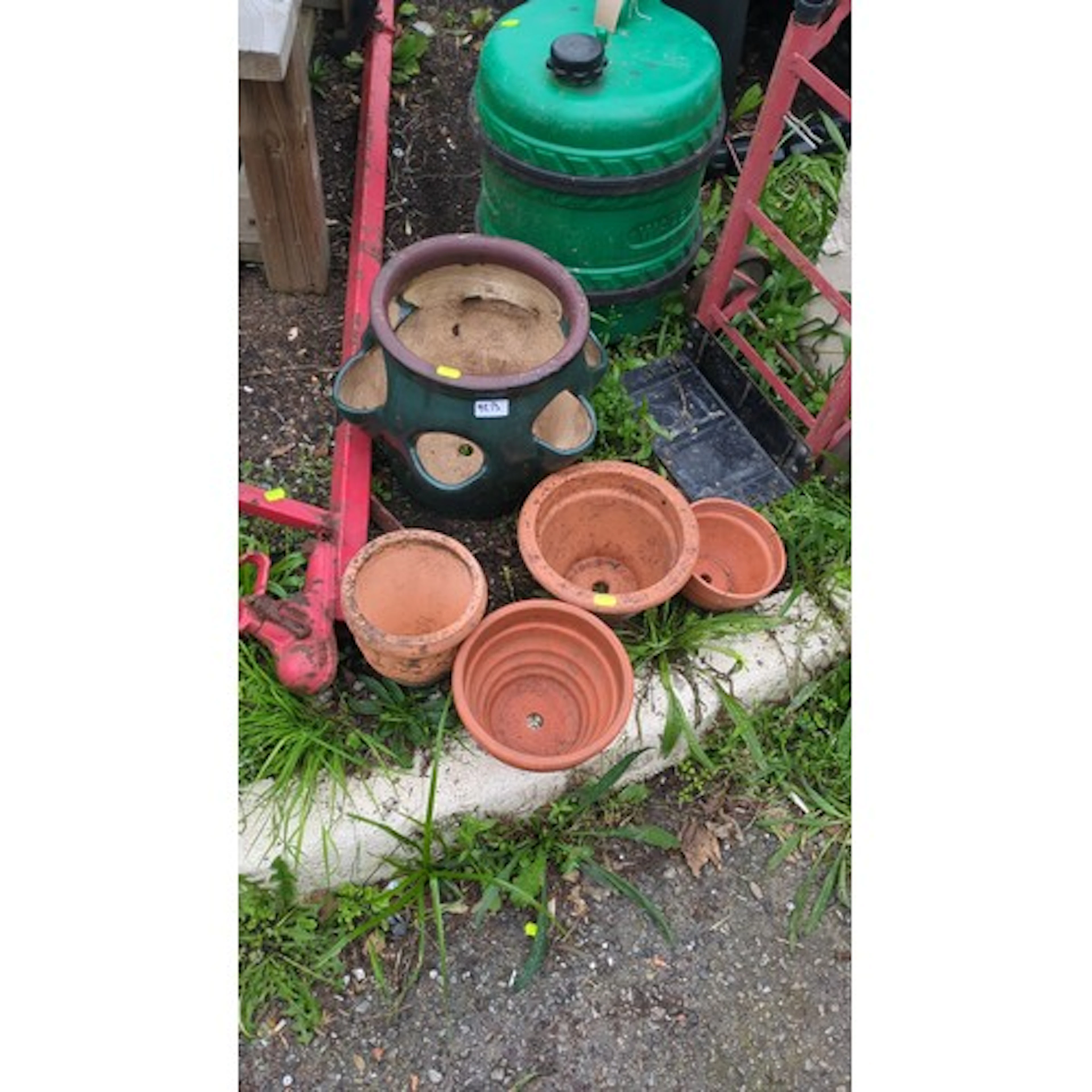 An assortment of garden planters including a glazed ceramic ...