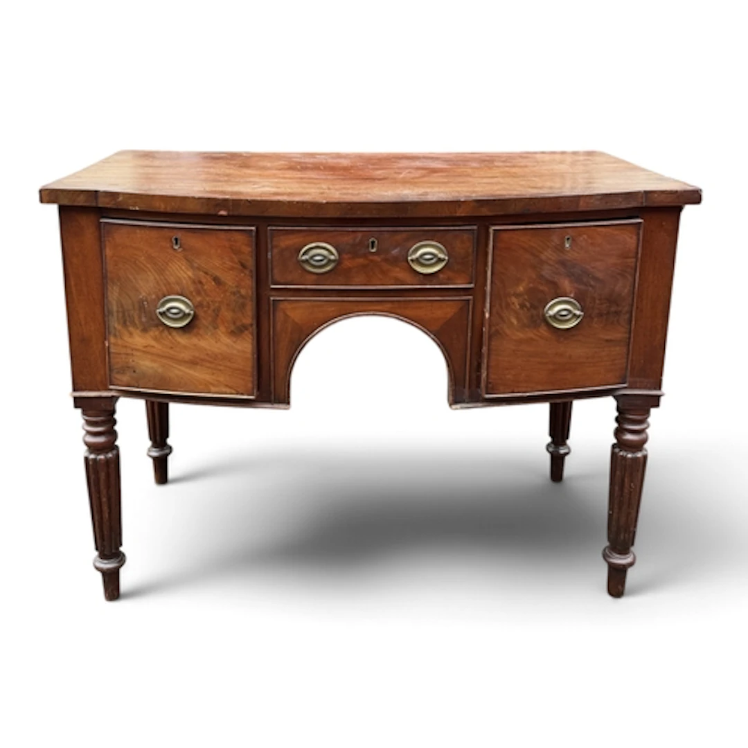 A WILLIAM IV MAHOGANY BOWFRONTED SIDEBOARD Fitted with two d...