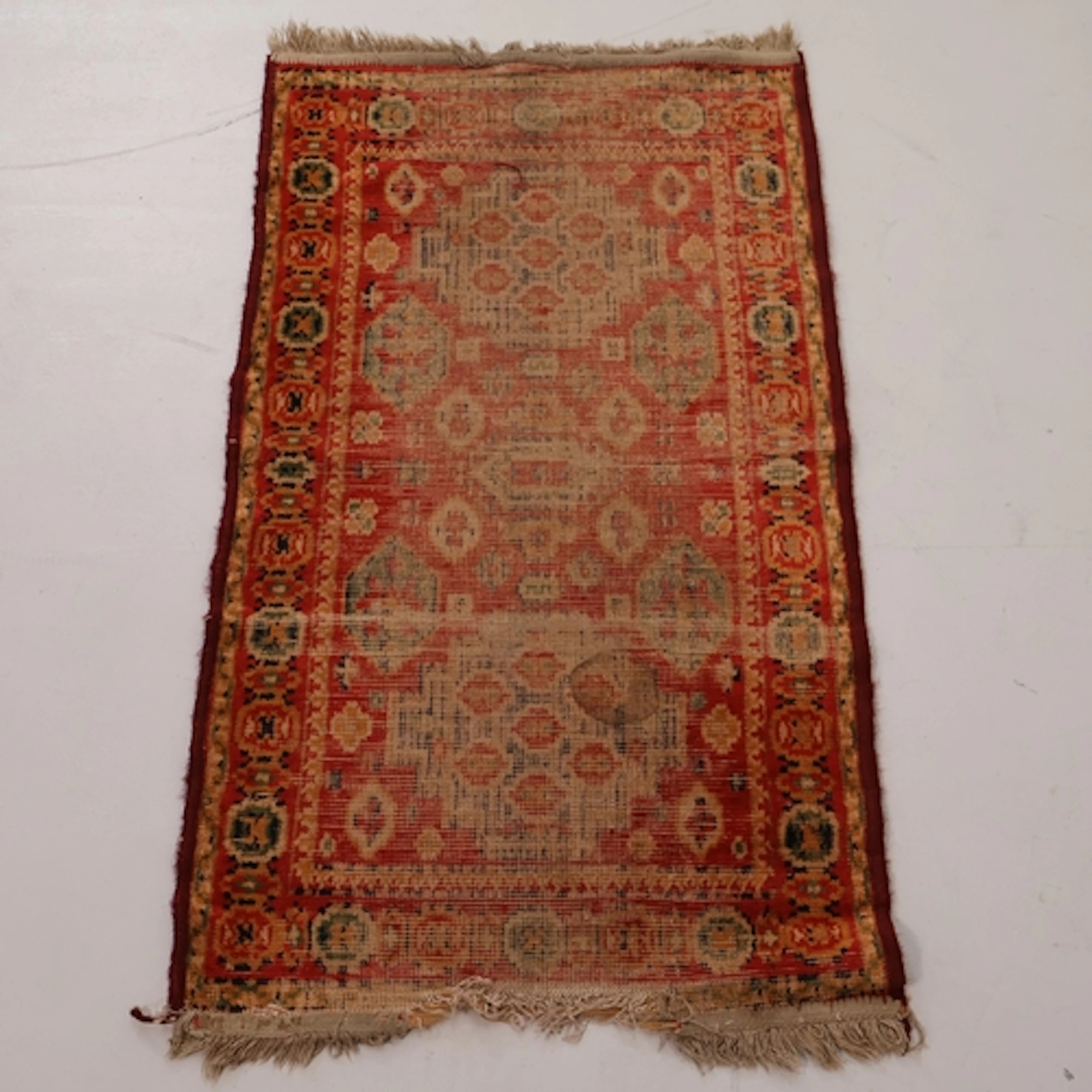 A small red ground Afghan rug, L100cm, W56cm.
