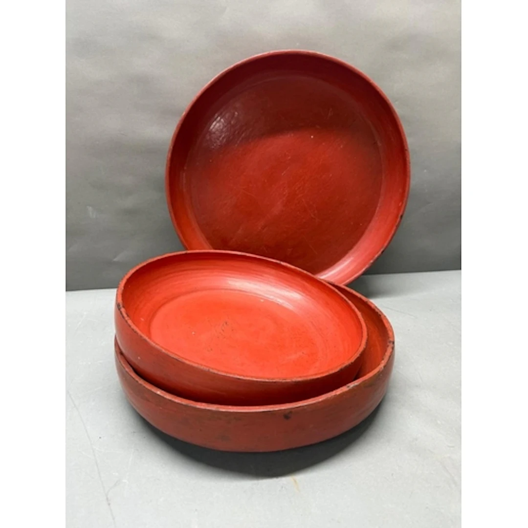 Three Burmese folk art red ochre dishes.