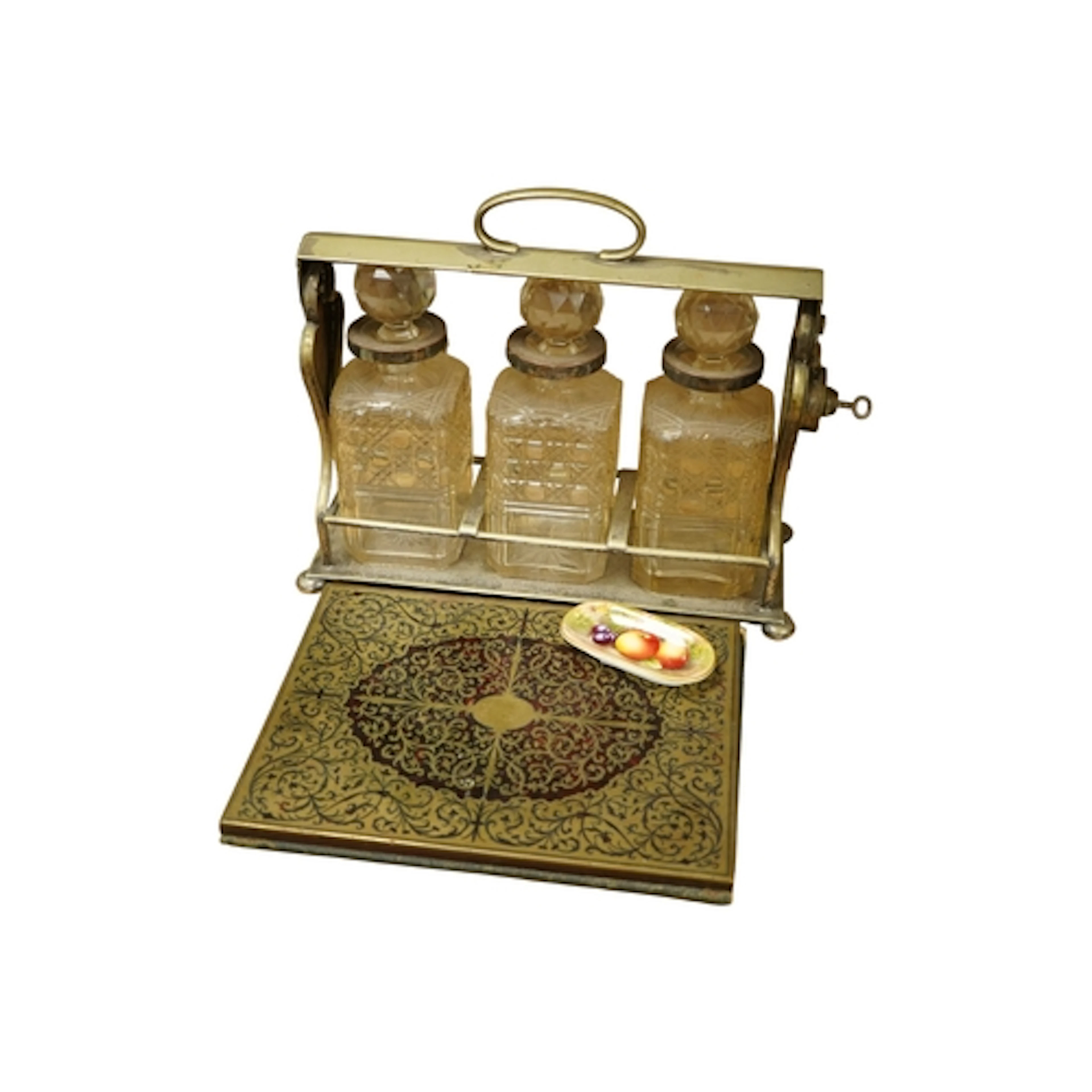 A Victorian silver plated tantalus, a mid 19th century brass...