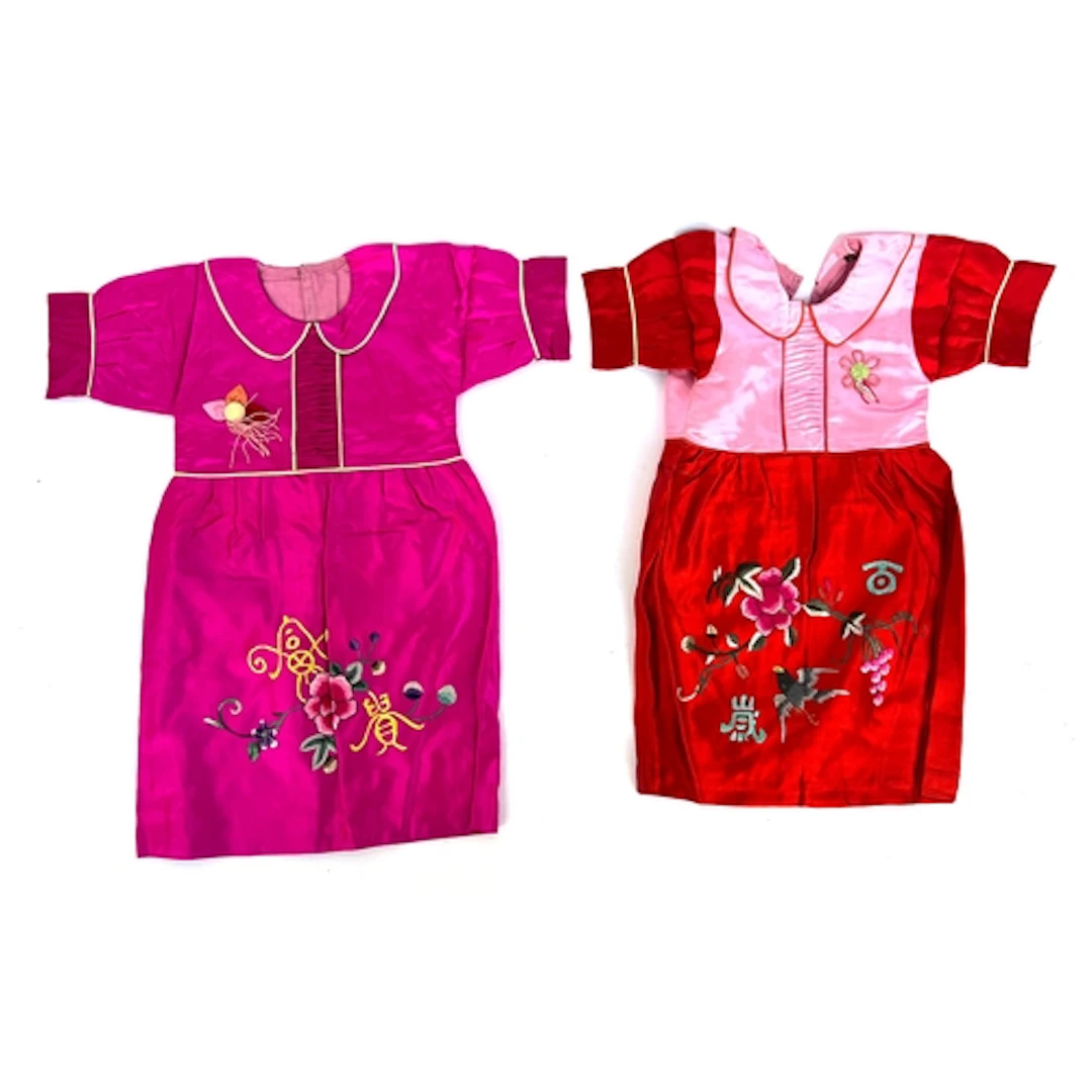 Two early 20th century Chinese silk children's short sleeved...