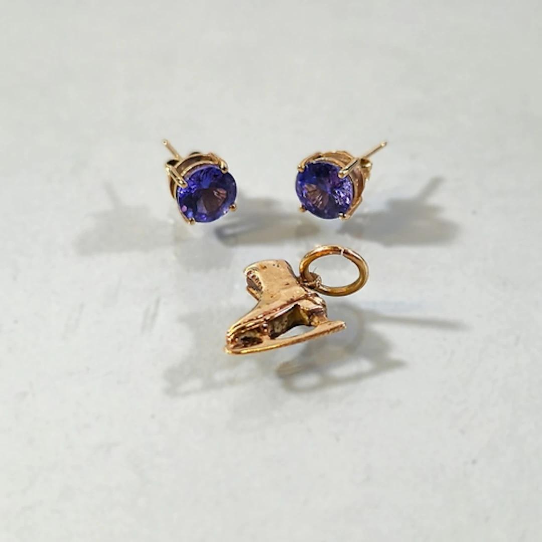 Pair of 9ct gold and tanzanite earrings, set with a round cu...