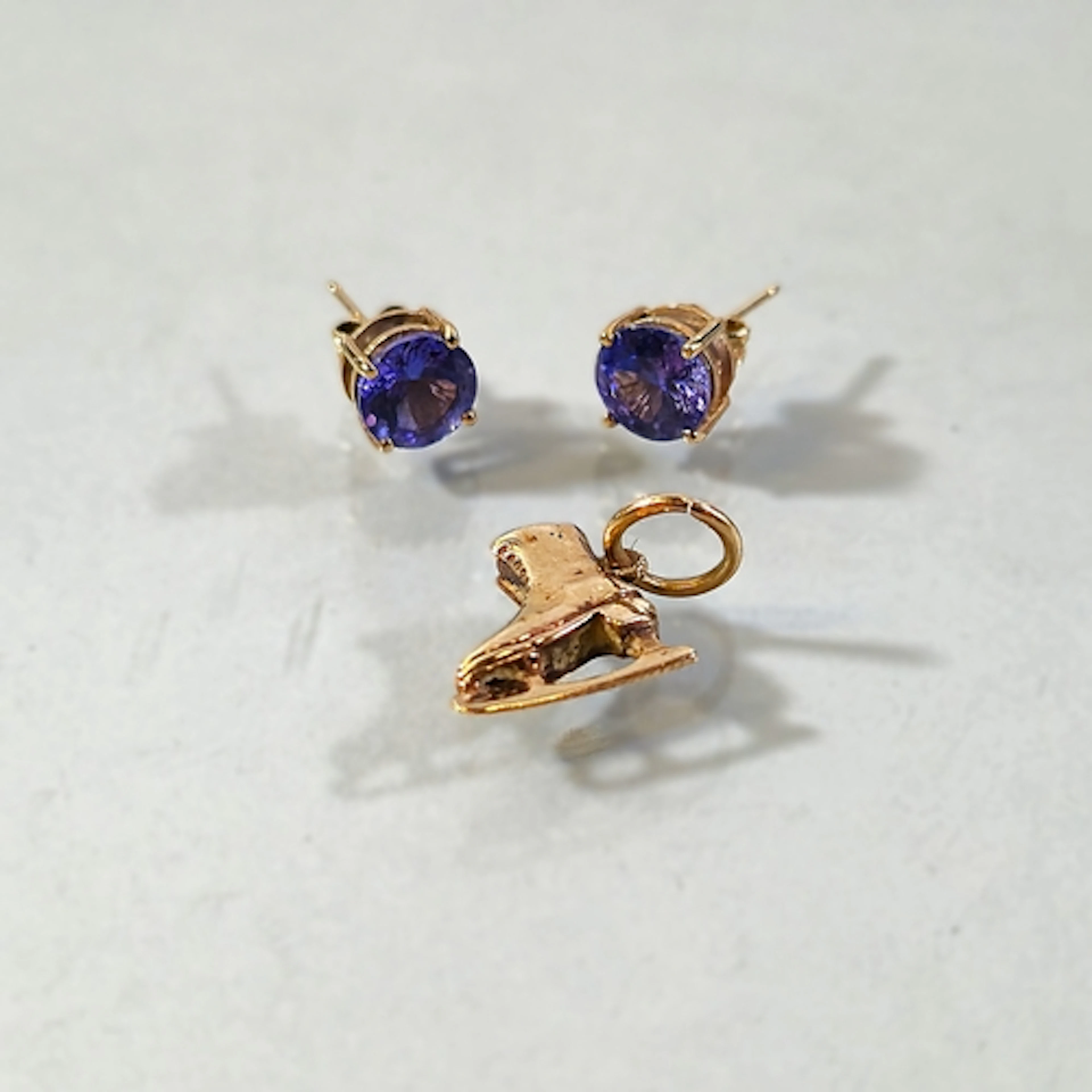 Pair of 9ct gold and tanzanite earrings, set with a round cu...
