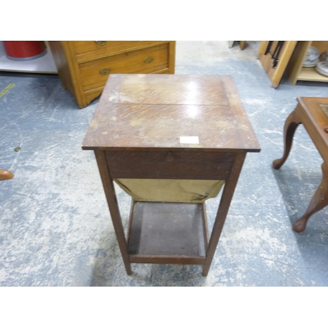 Oak two tier sewing table with fabric pull out compartment.