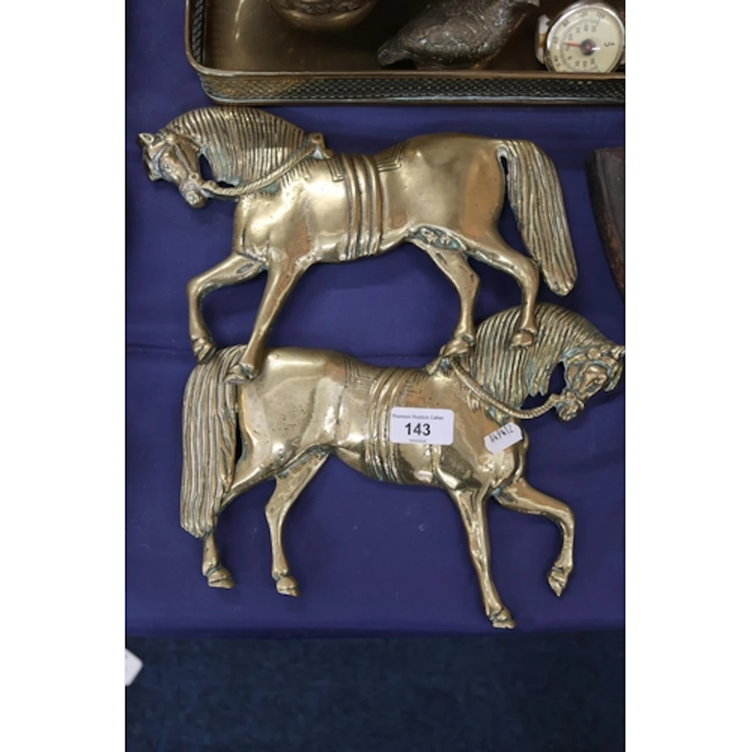 Pair of brass horse plaques.