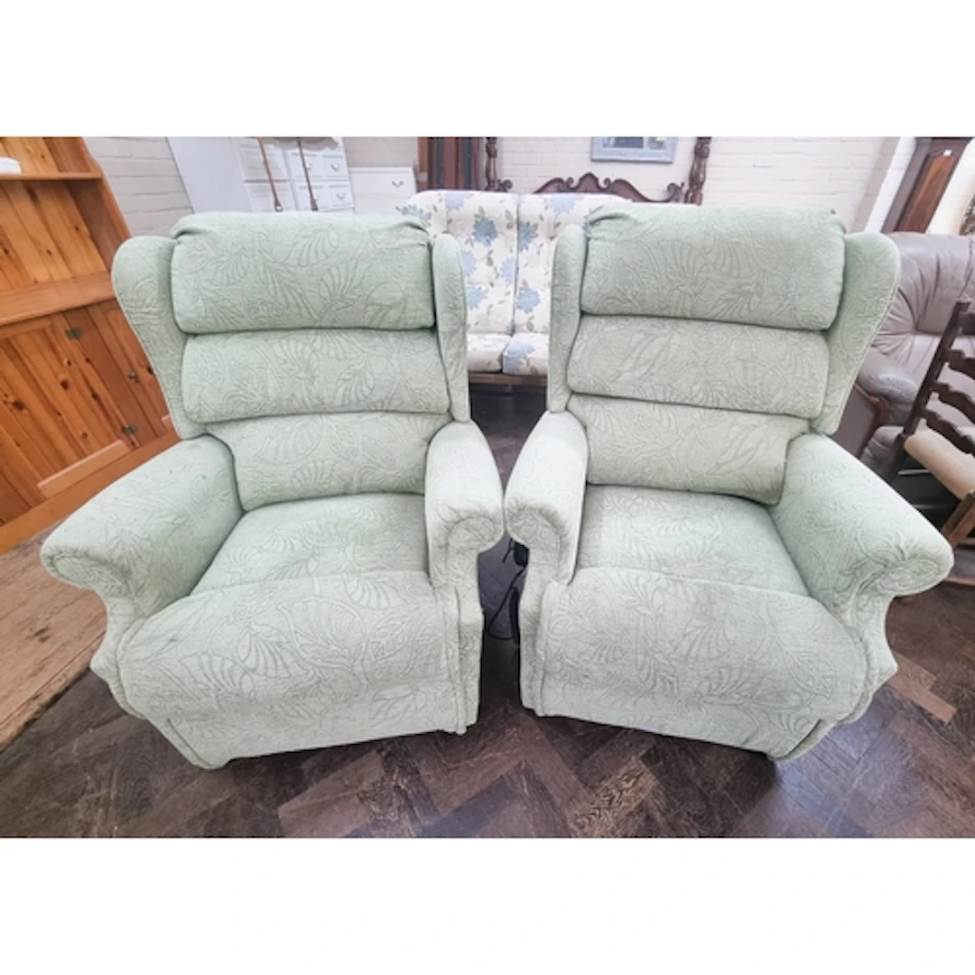 A pair of pale green upholstered electrically operated recli...