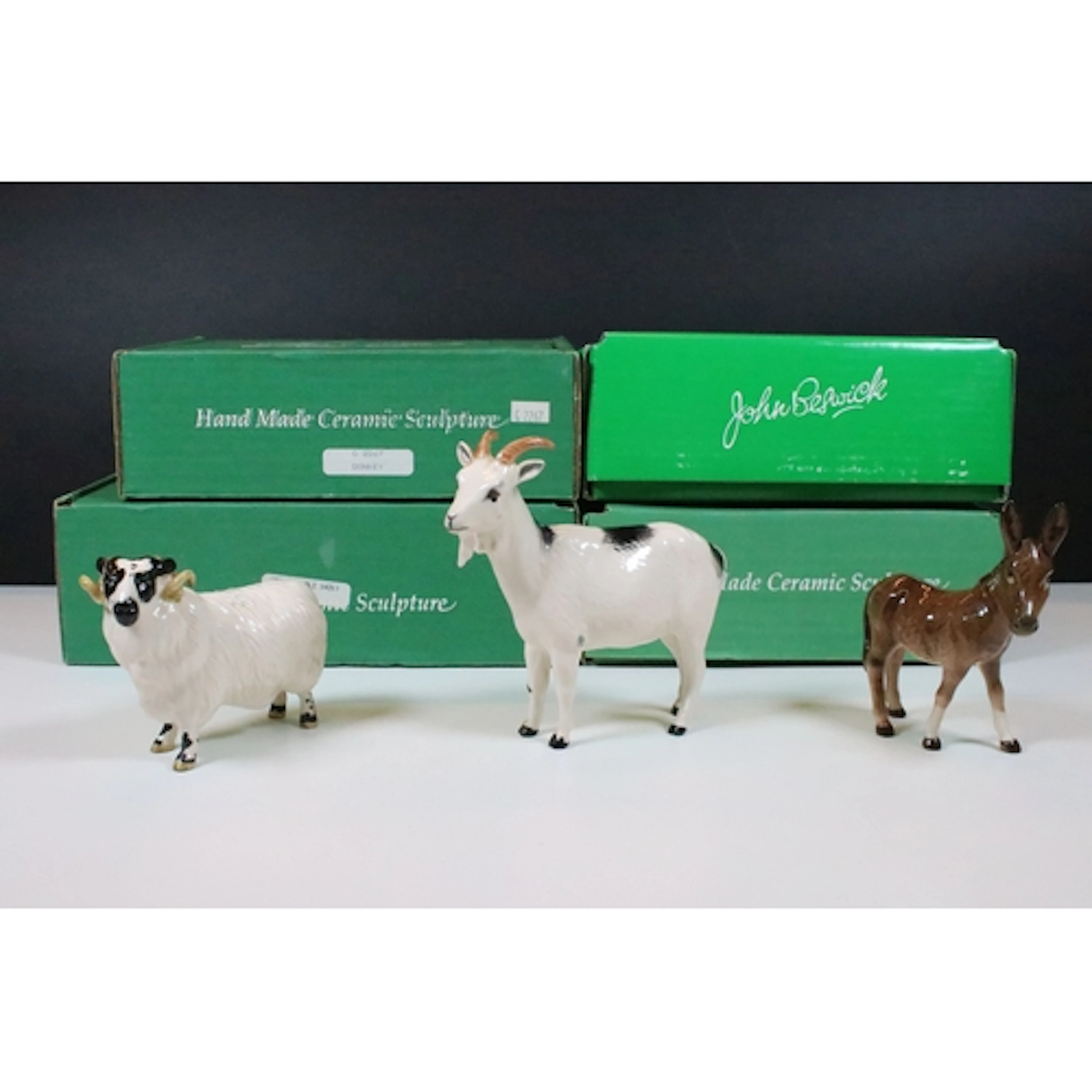 Group of four boxed Beswick figures, including Black Faced R...