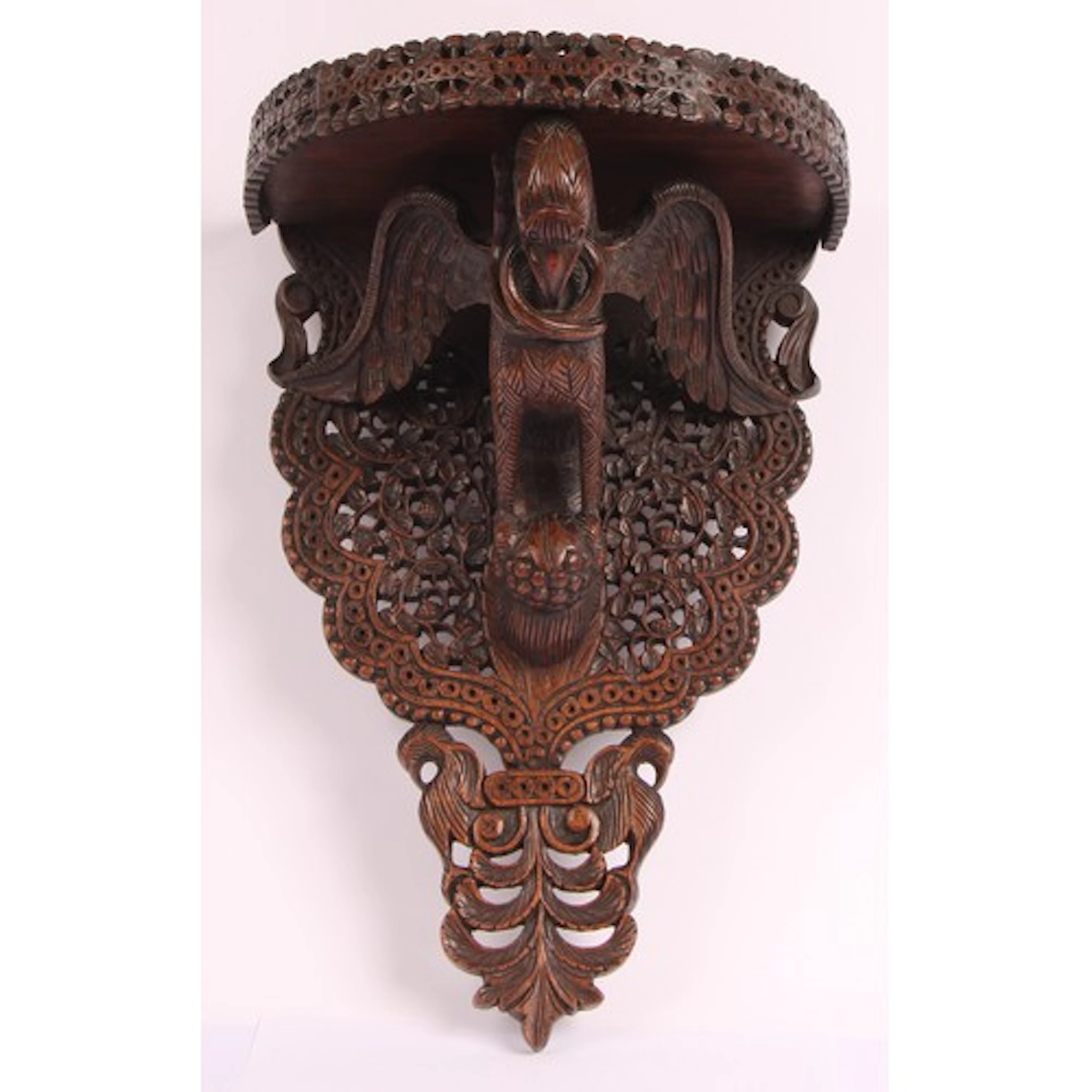An Anglo-Indian or Burmese hardwood demilune wall shelf, the...