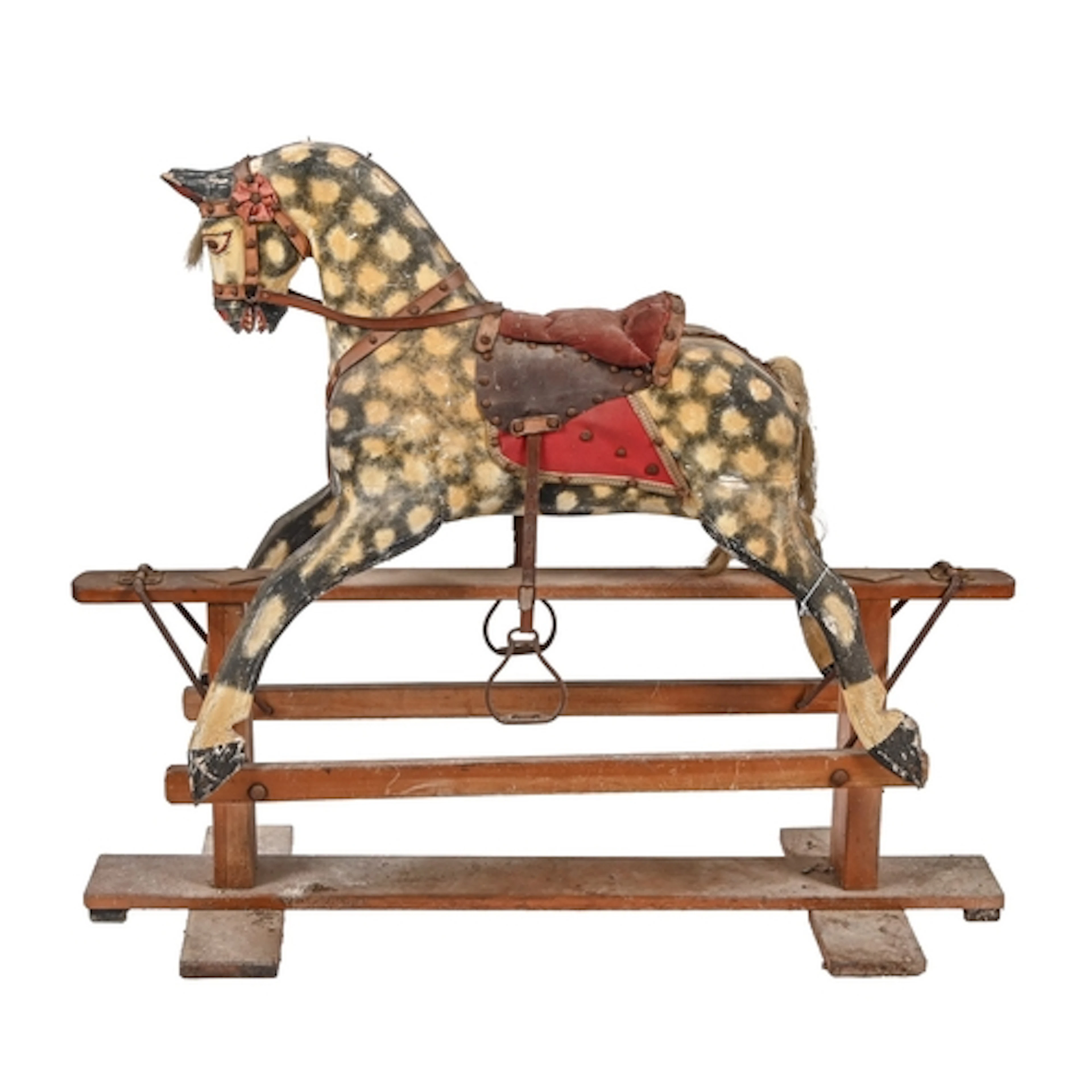 A painted pine rocking horse, early 20th c, with nailed meta...