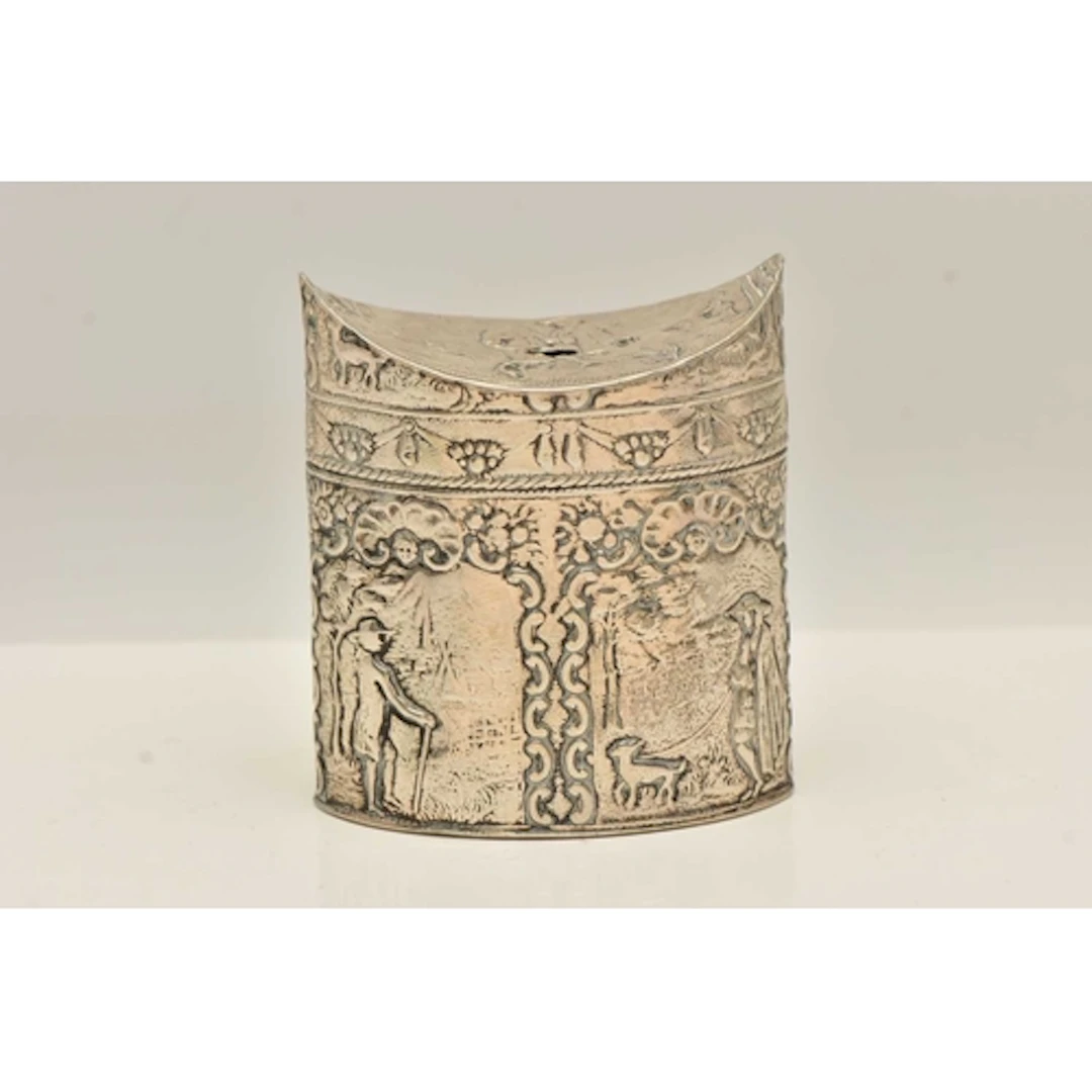 A CONTINETAL WHITE METAL CADDY, of an oval form, embossed pa...