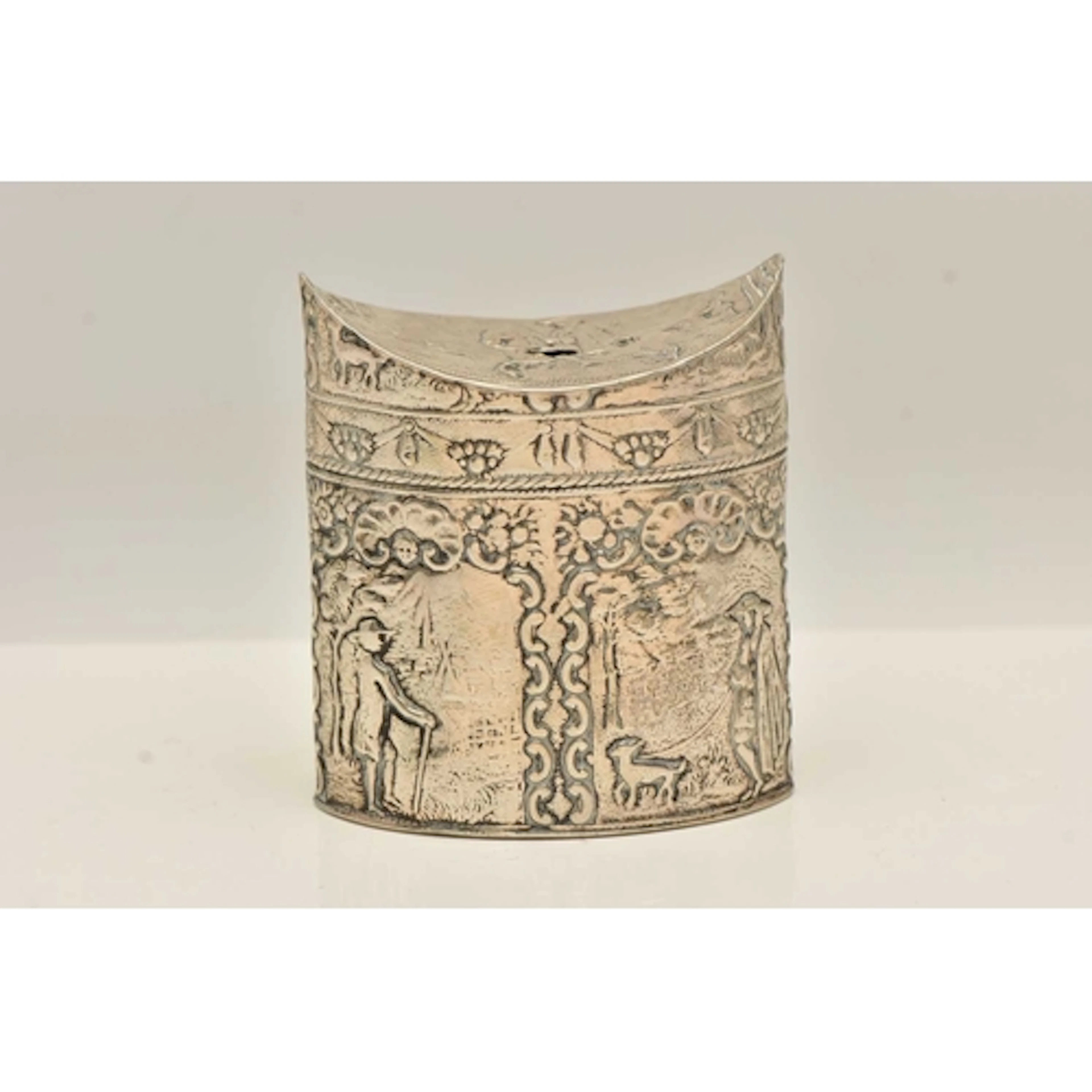 A CONTINETAL WHITE METAL CADDY, of an oval form, embossed pa...