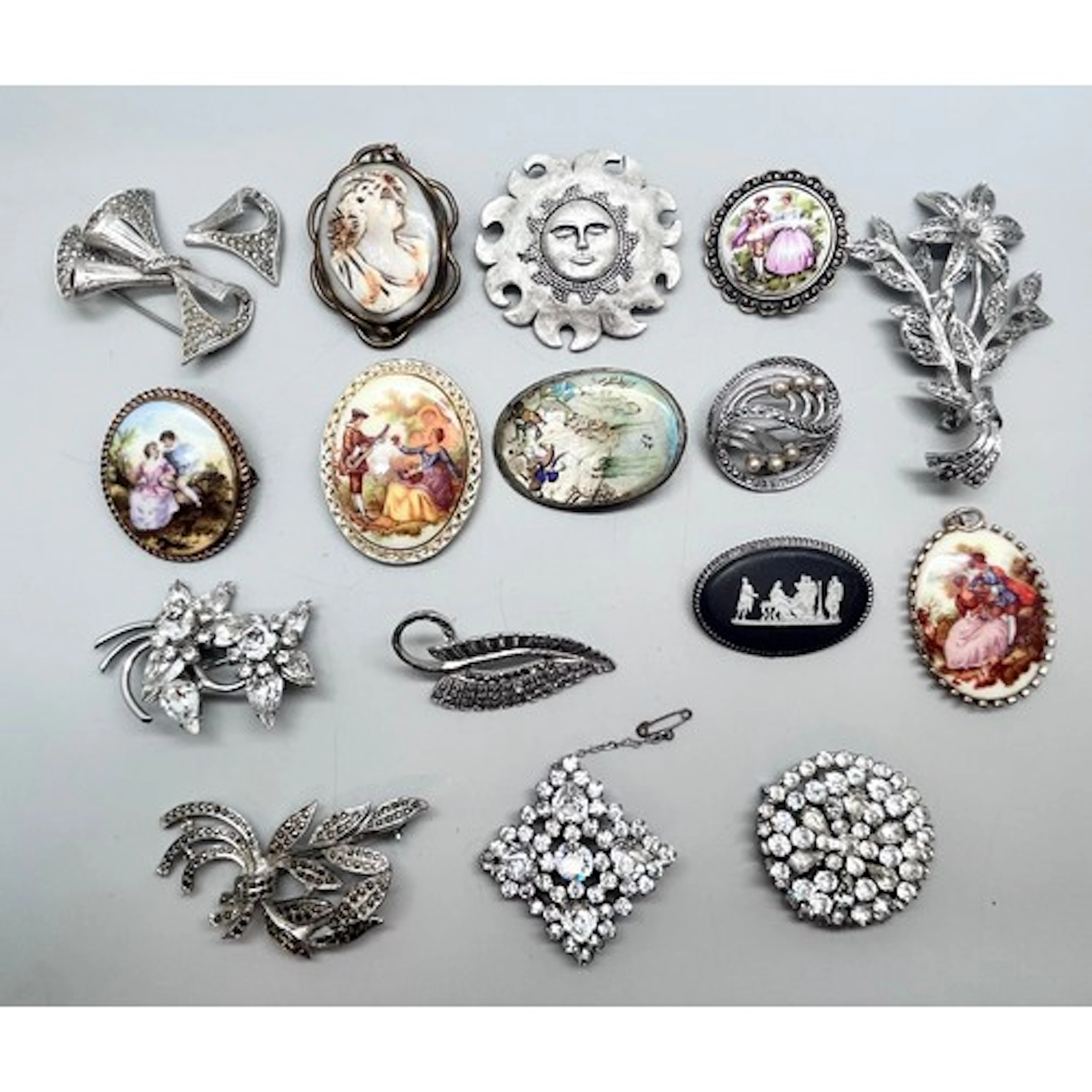 A collection of vintage costume brooches