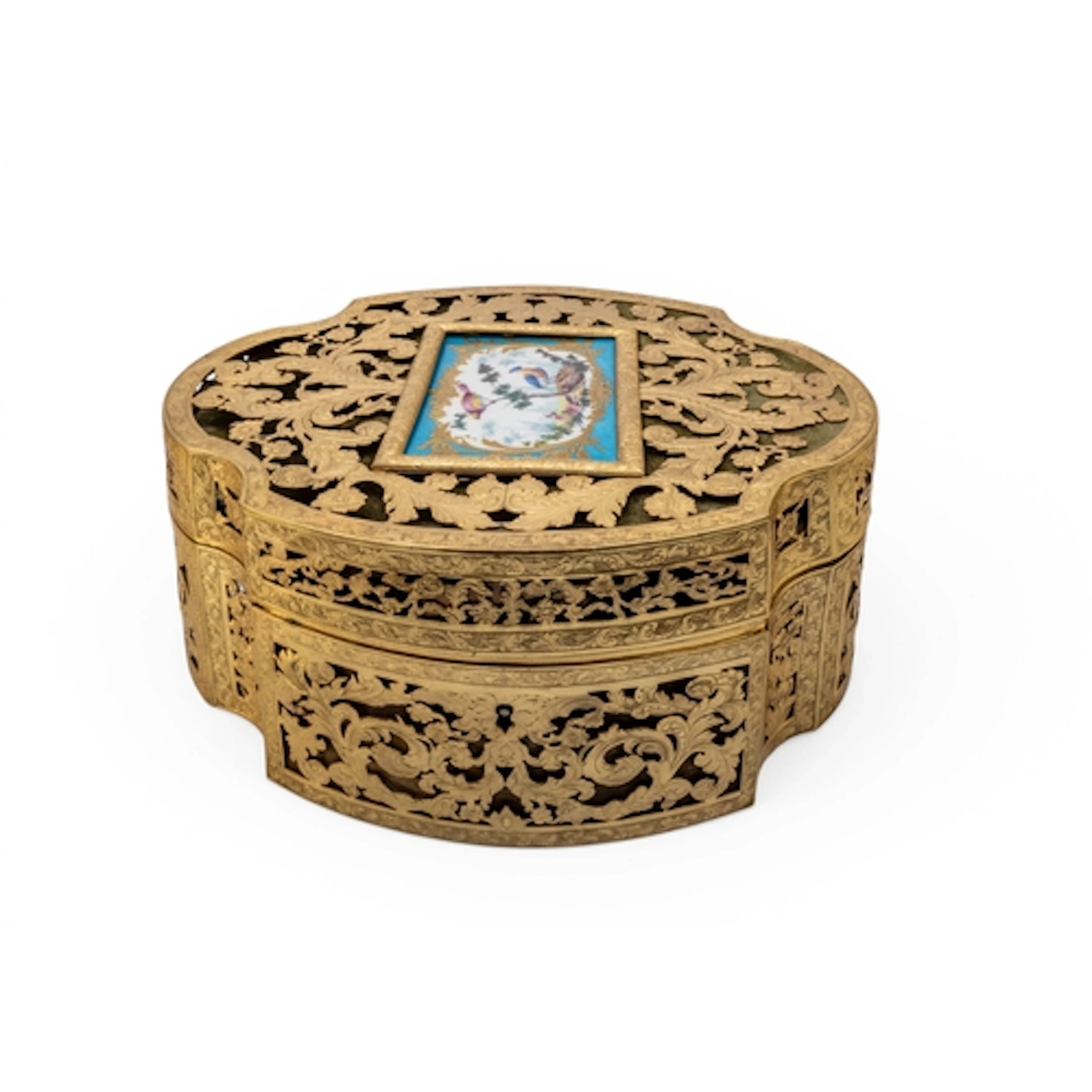 A FANCY GILT BRASS RETICULATED BOX of canted oval form pierc...