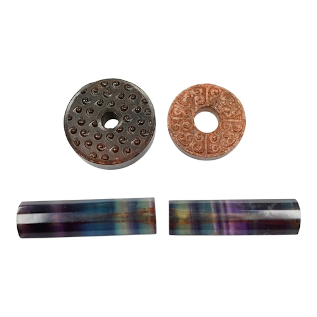 Two Chinese archaistic hardstone discs and two crystal facet...