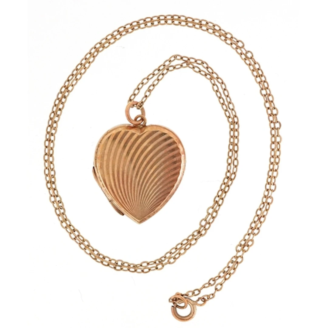 9ct gold engine turned love heart locket on a 9ct gold neckl...
