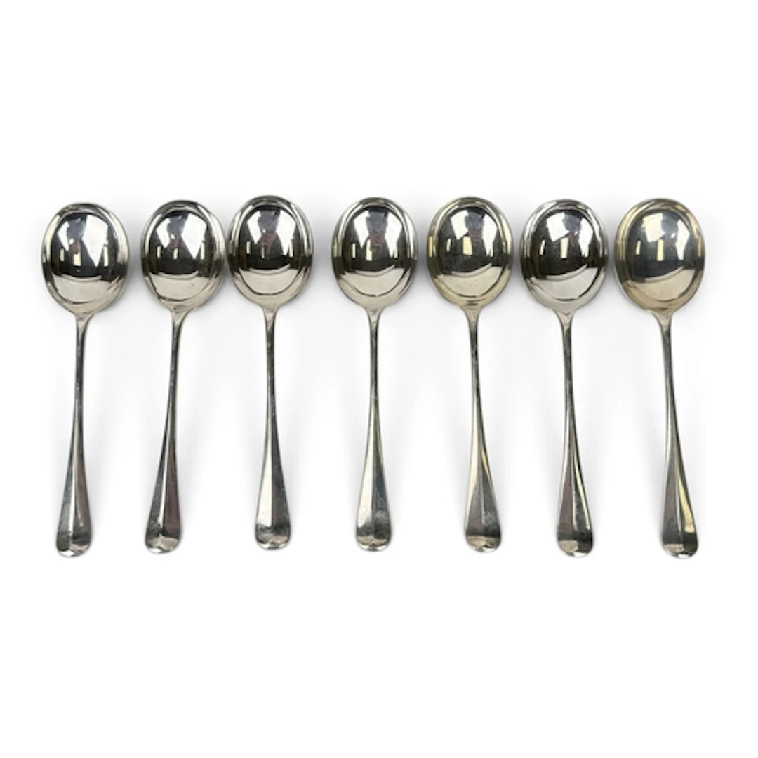 A SET OF SEVEN SILVER HANOVERIAN RAT TAIL PATTERN SOUP SPOON...