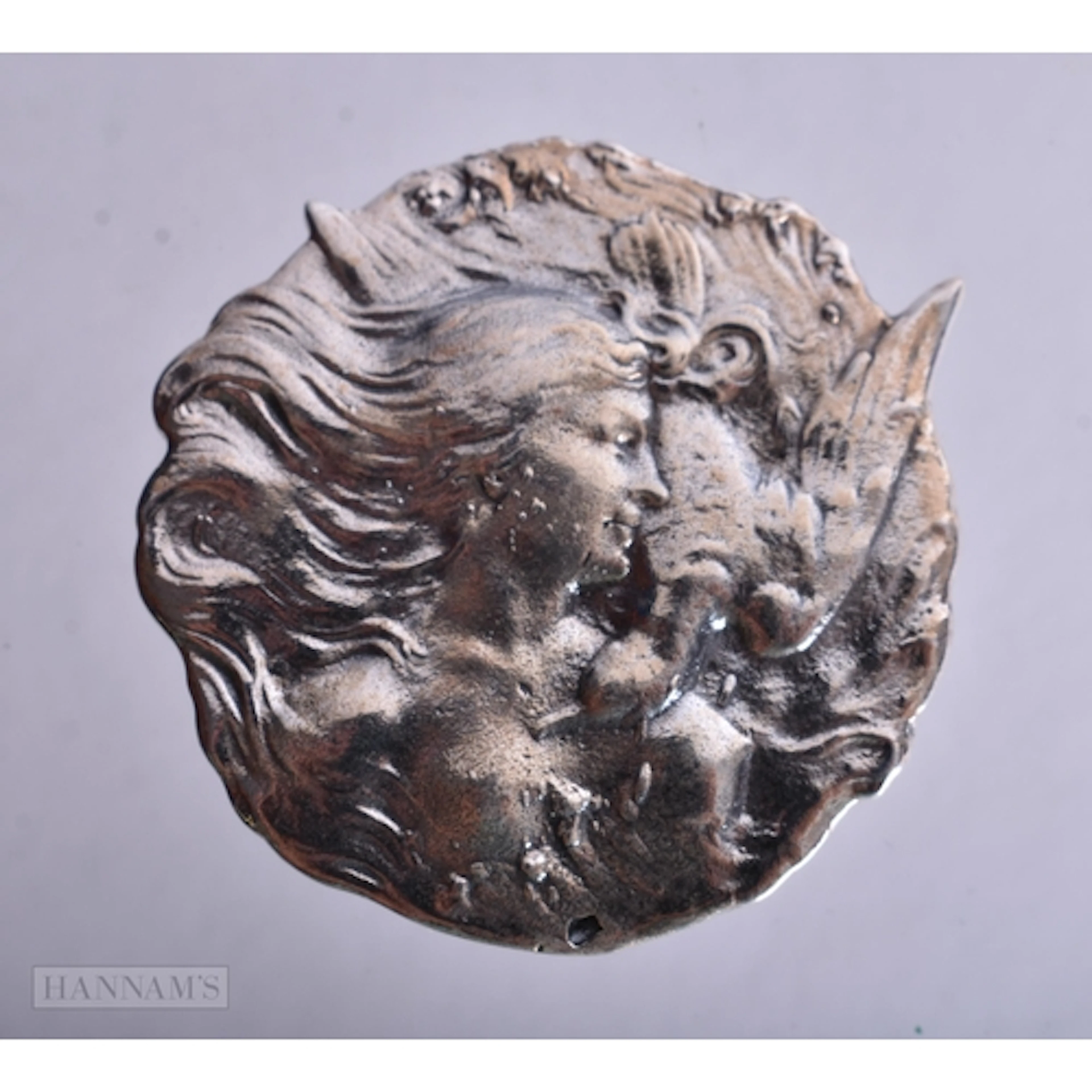 A Sterling Silver Brooch with an Embossed Design of an Art N...