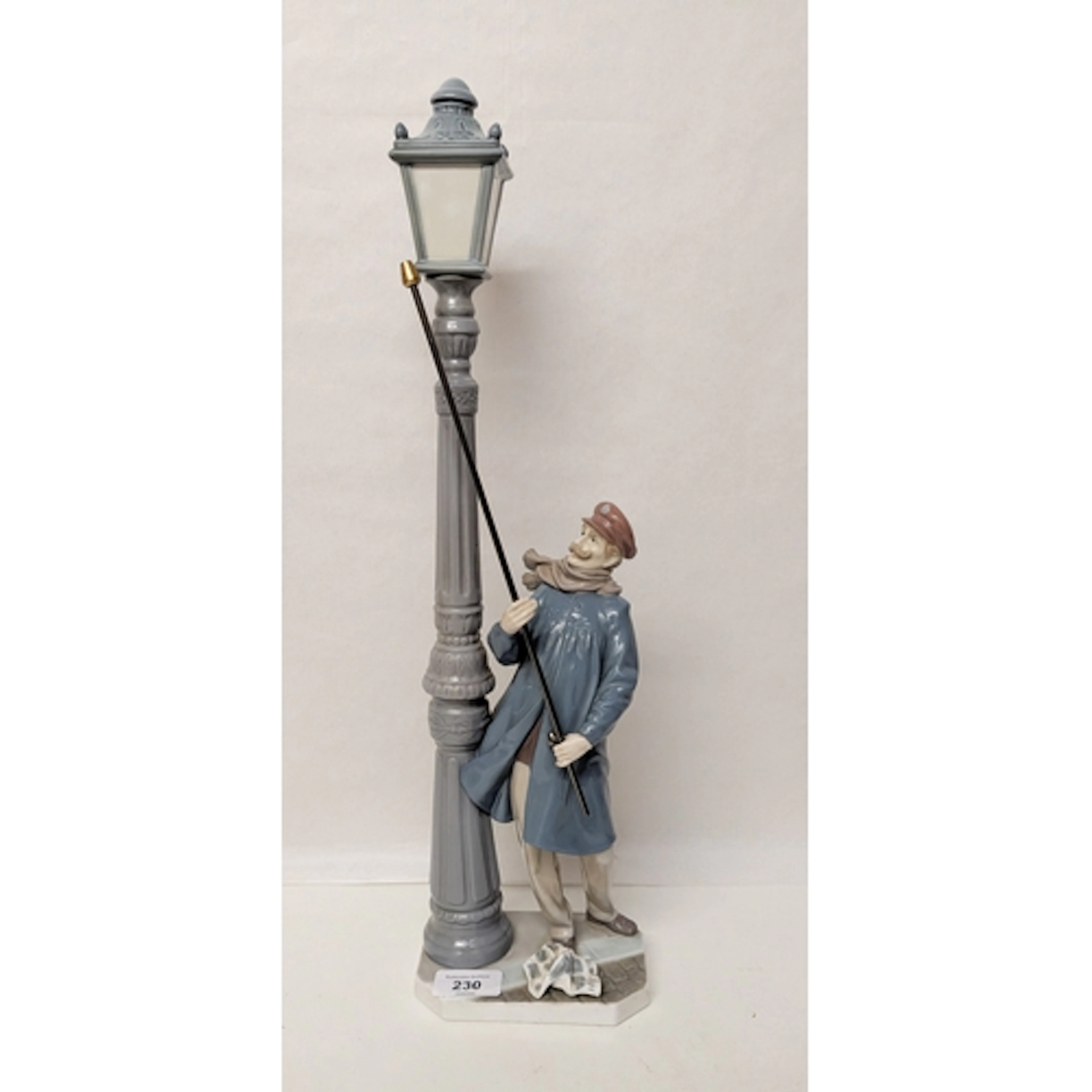 A Lladro porcelain figurine: Lamplighter, standing approx 47...