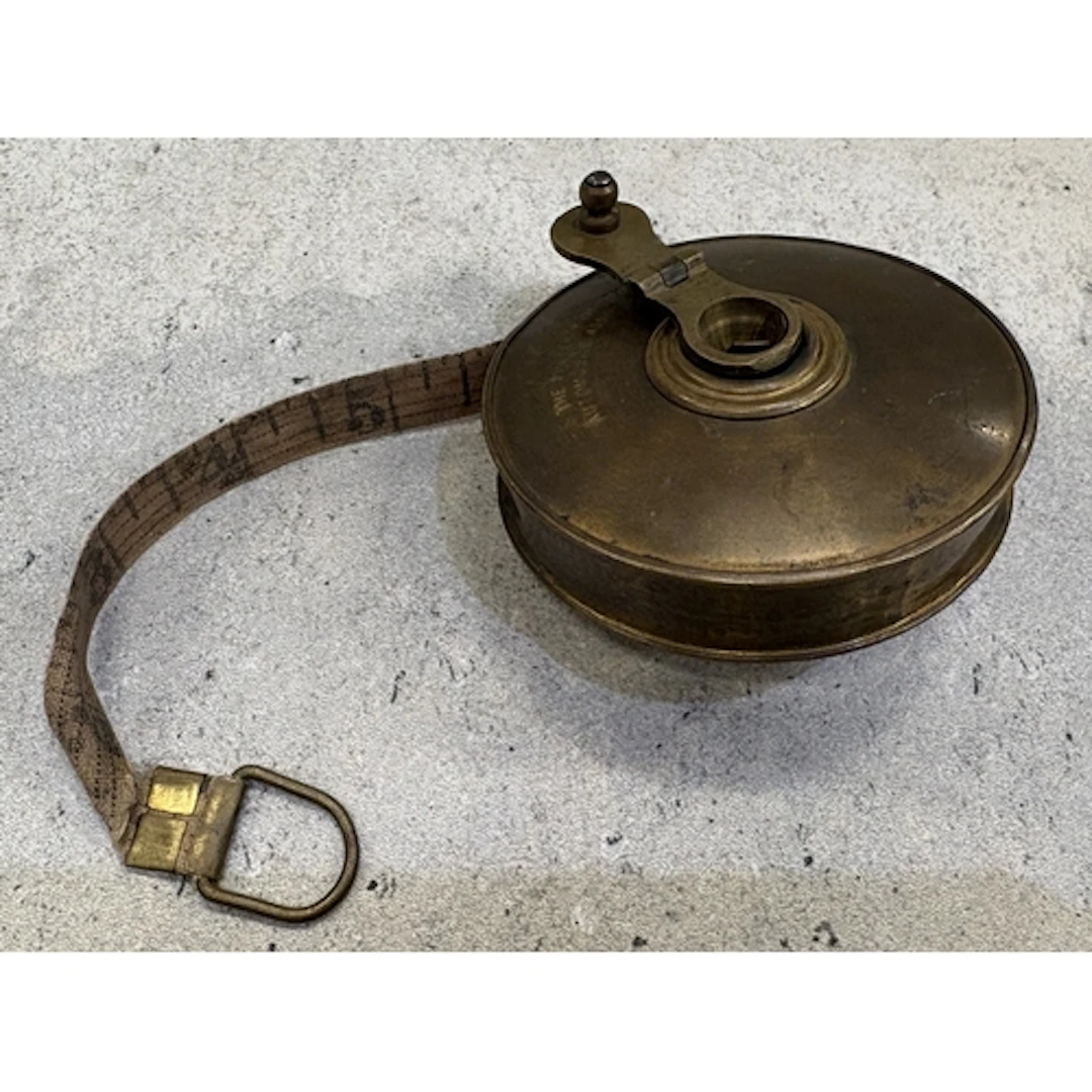 A vintage AA Patrolman's brass and canvas tape measure. Est....