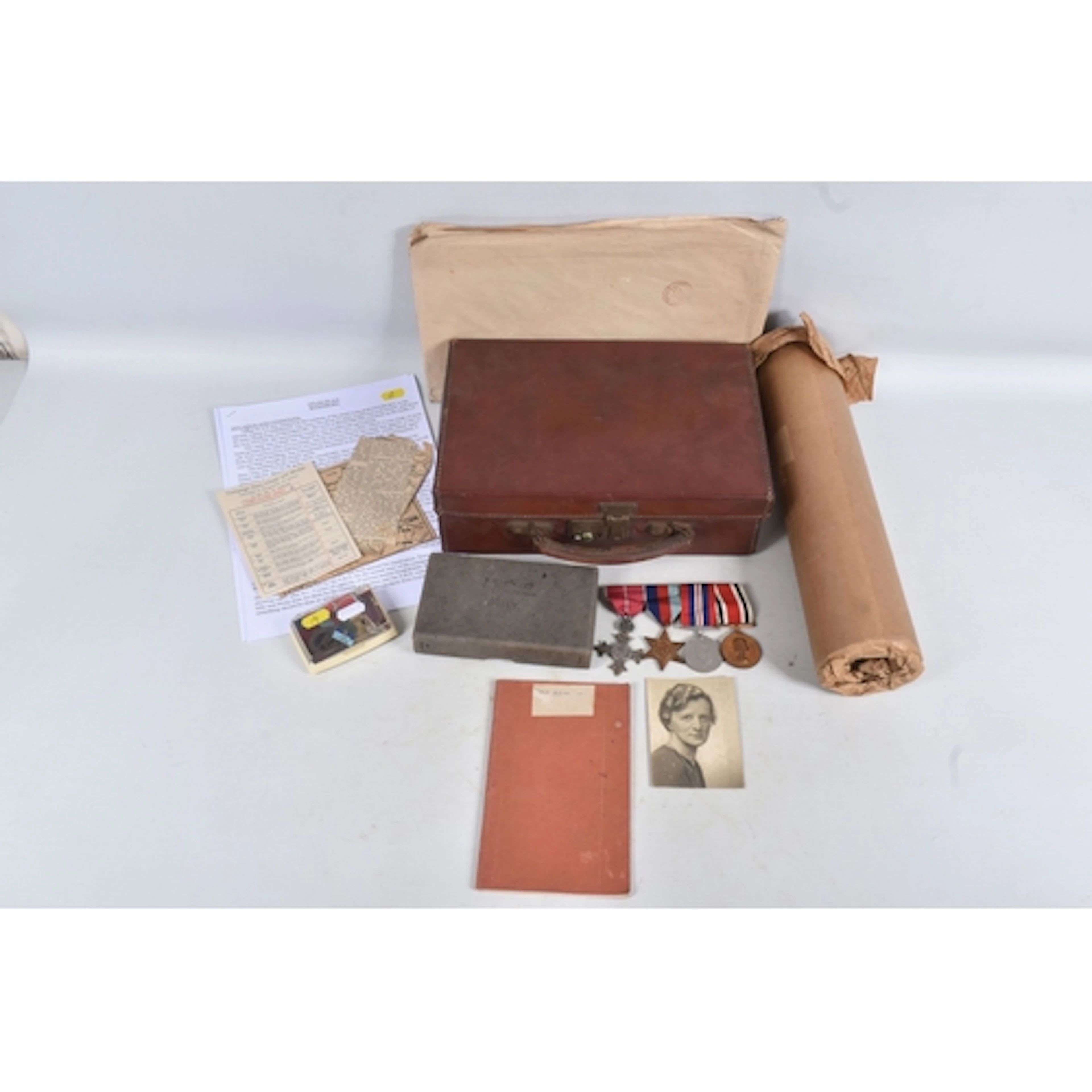 A SMALL BROWN LEATHER CARRY CASE, CONTAINING THE MILITARY AR...