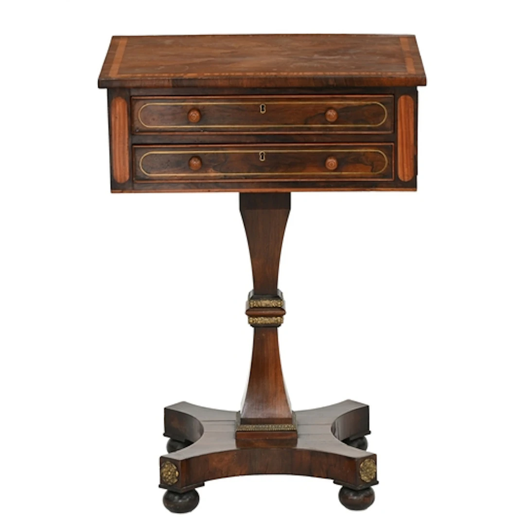 A George IV rosewood and brass line inlaid work table, the r...
