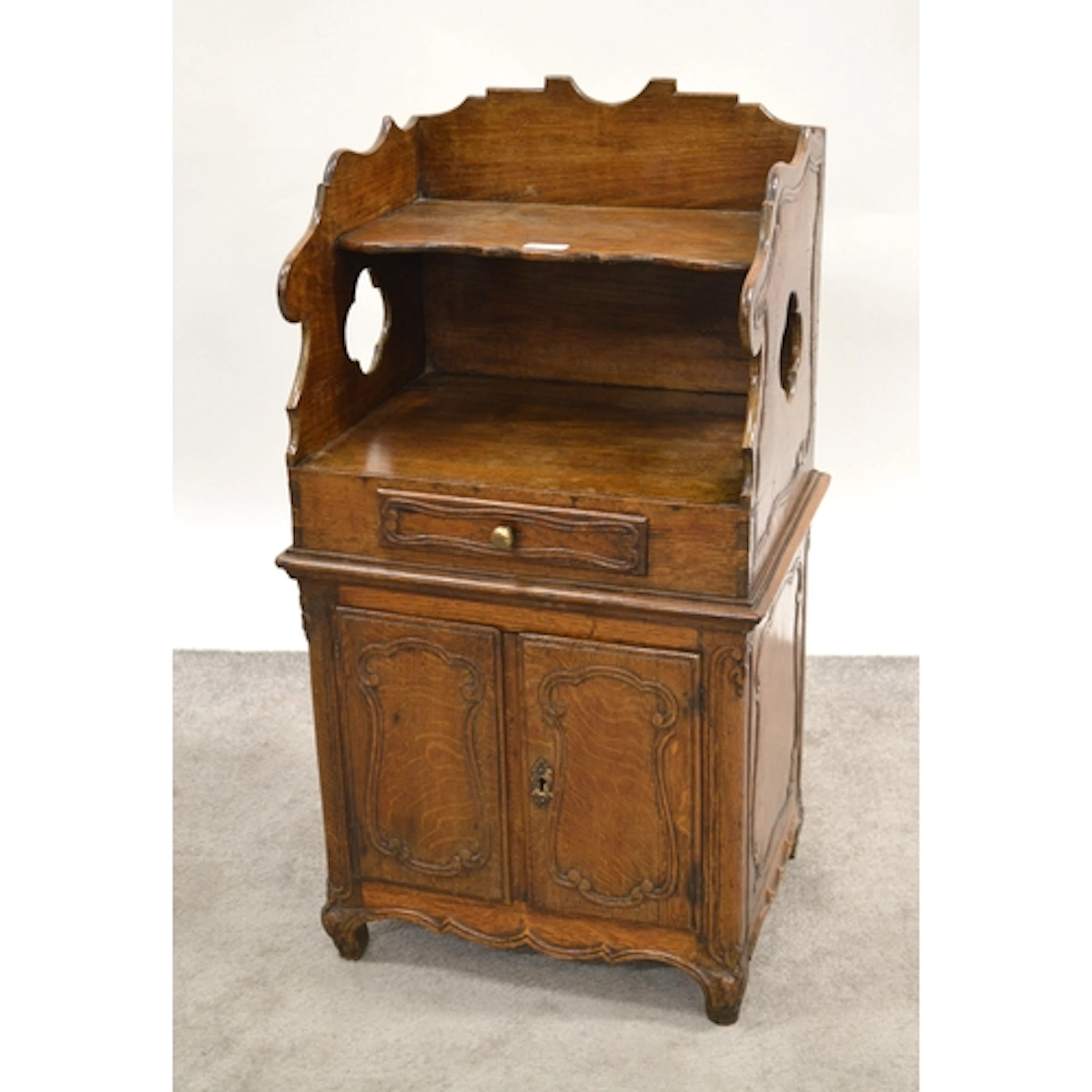 French oak bedside cabinet, having galleried shelved top, ab...