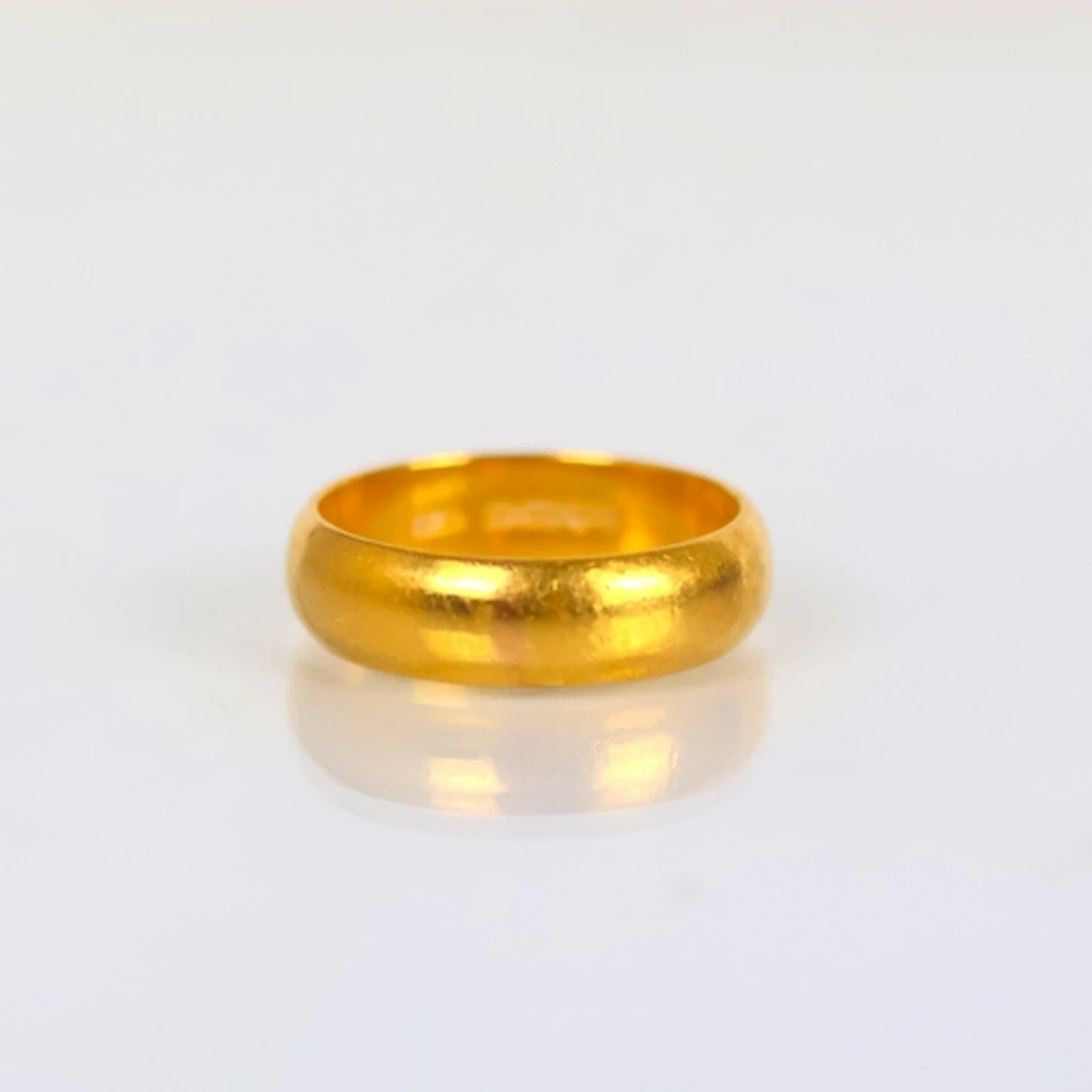 A 22ct yellow gold wedding band, stamped 'WM' Birmingham 196...