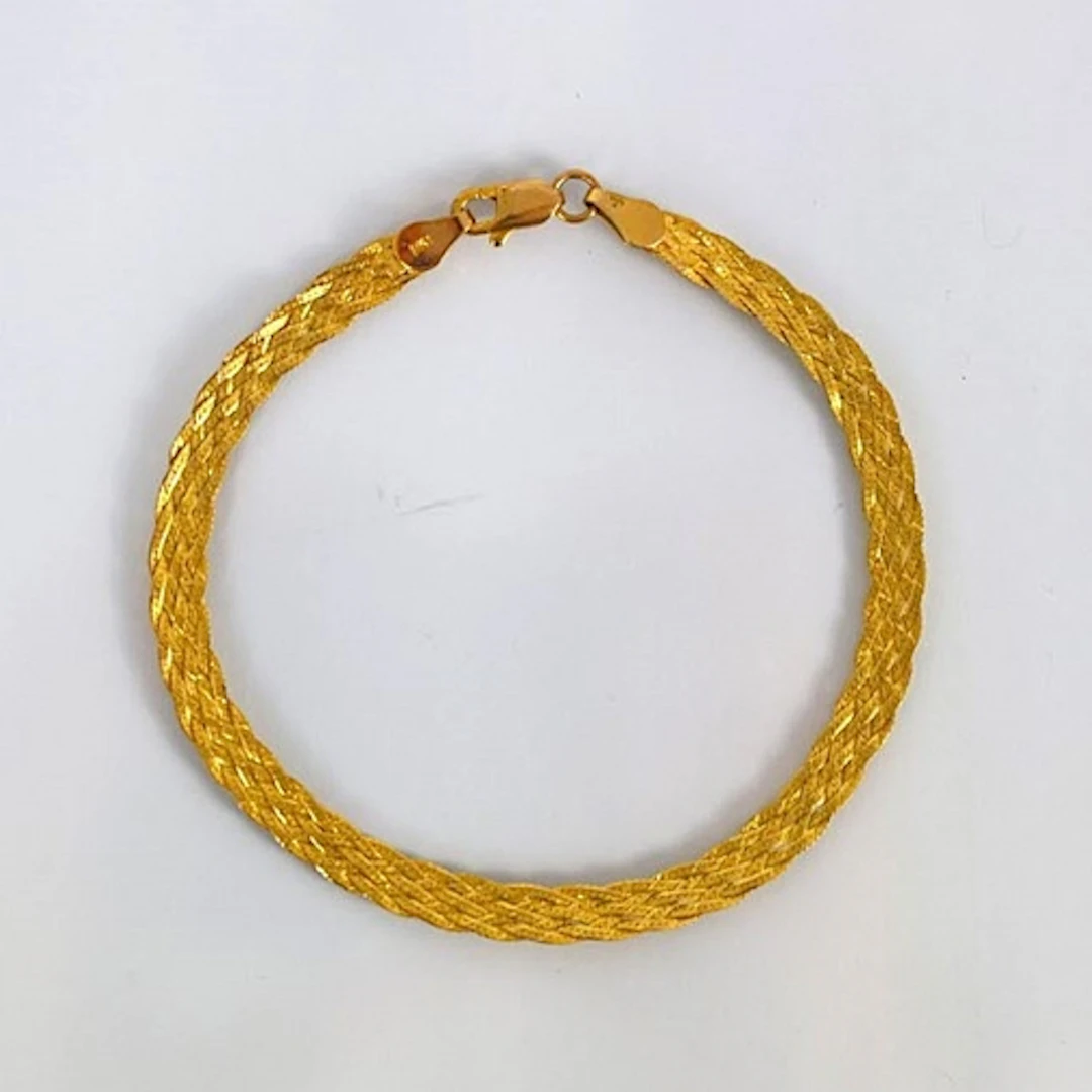 A contemporary 9ct gold bracelet, possibly Italian, the text...