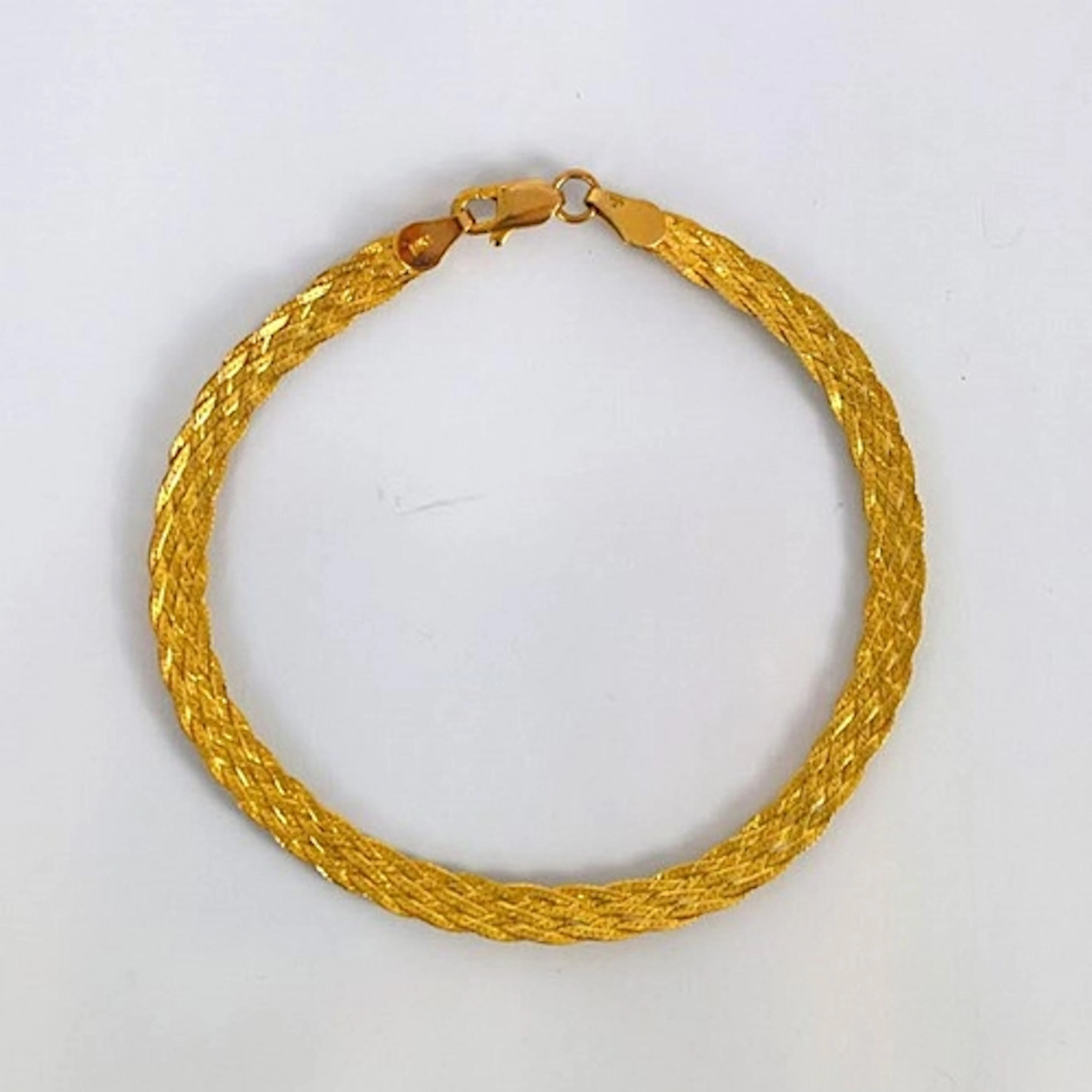 A contemporary 9ct gold bracelet, possibly Italian, the text...