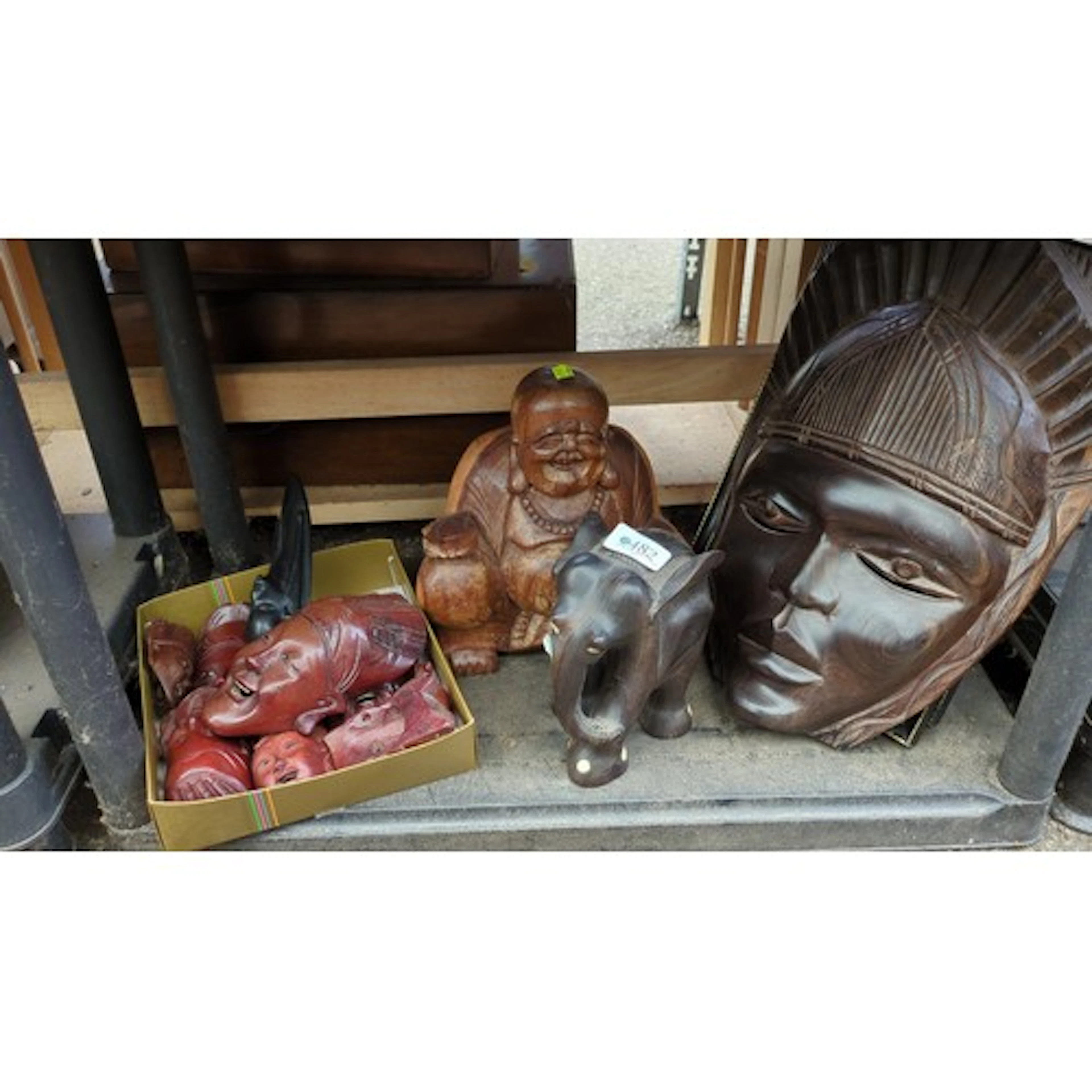 A group of carved wood decorative objects, comprising a larg...