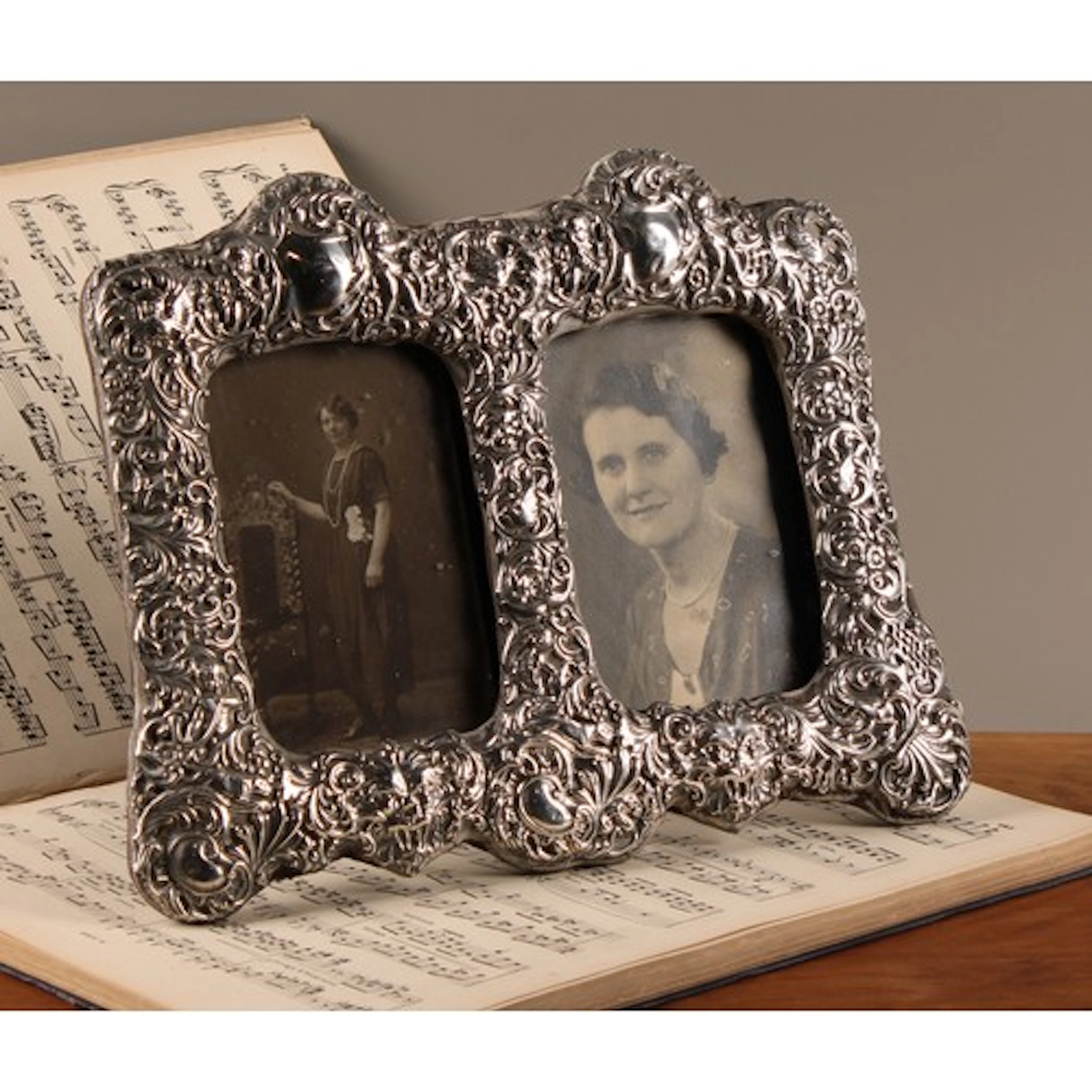 An Edwardian silver easel double photograph frame, embossed ...
