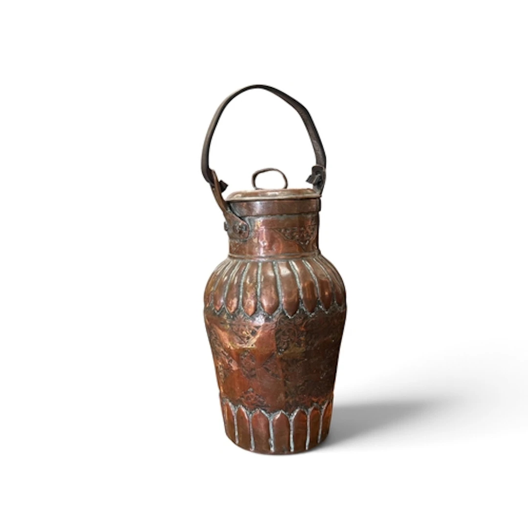 AN INDIAN 19TH CENTURY COPPER VESSEL The sides engraved with...