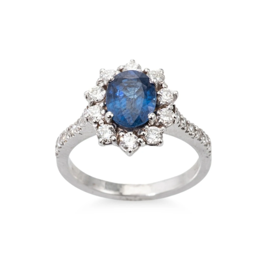A SAPPHIRE AND DIAMOND CLUSTER RING, the central oval sapphi...
