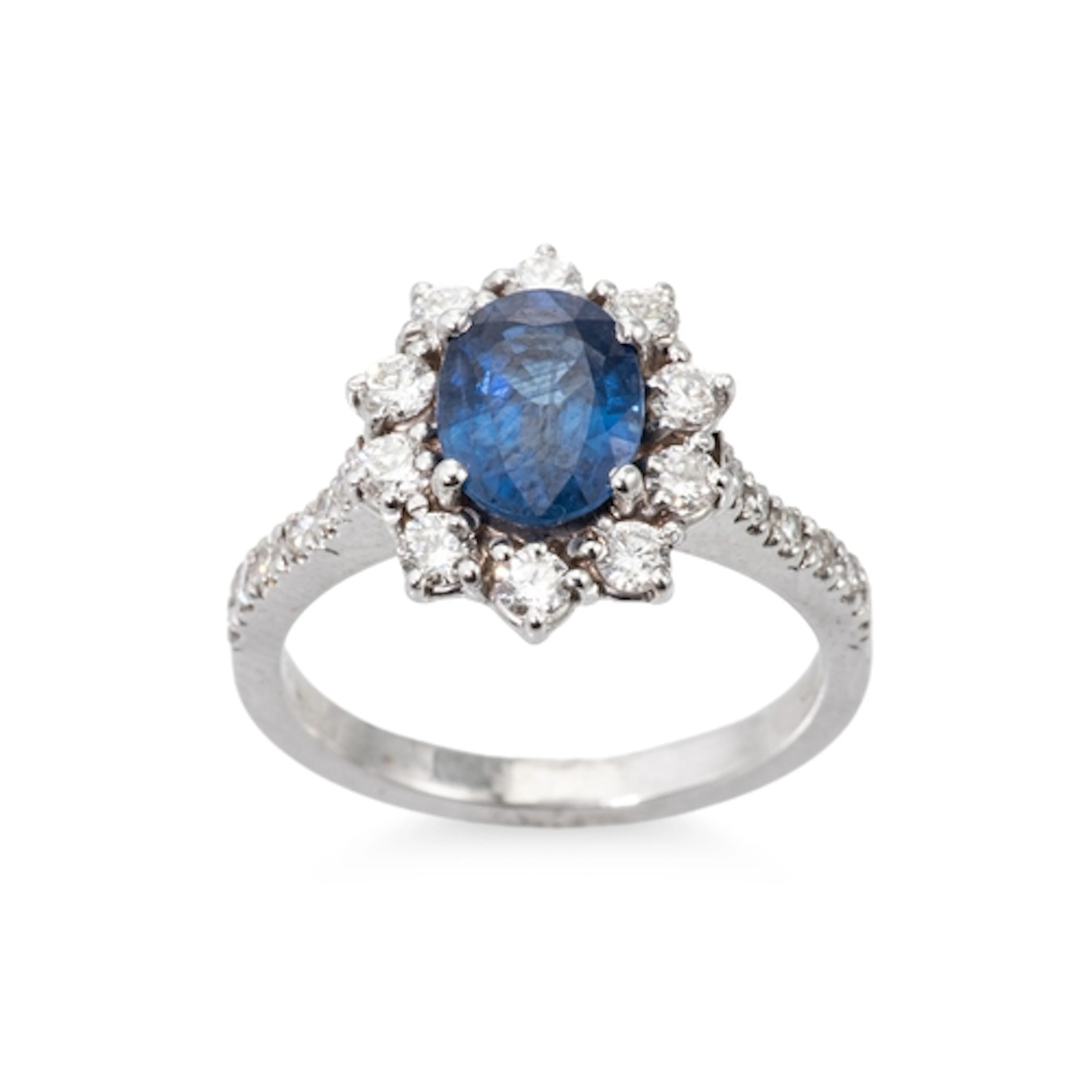 A SAPPHIRE AND DIAMOND CLUSTER RING, the central oval sapphi...
