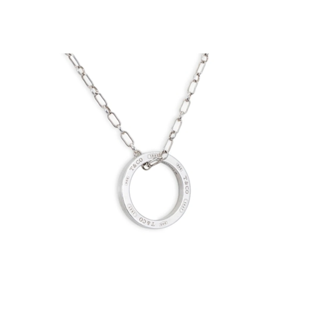 A TIFFANY STERLING SILVER CIRCULAR PENDANT, on a silver chai...