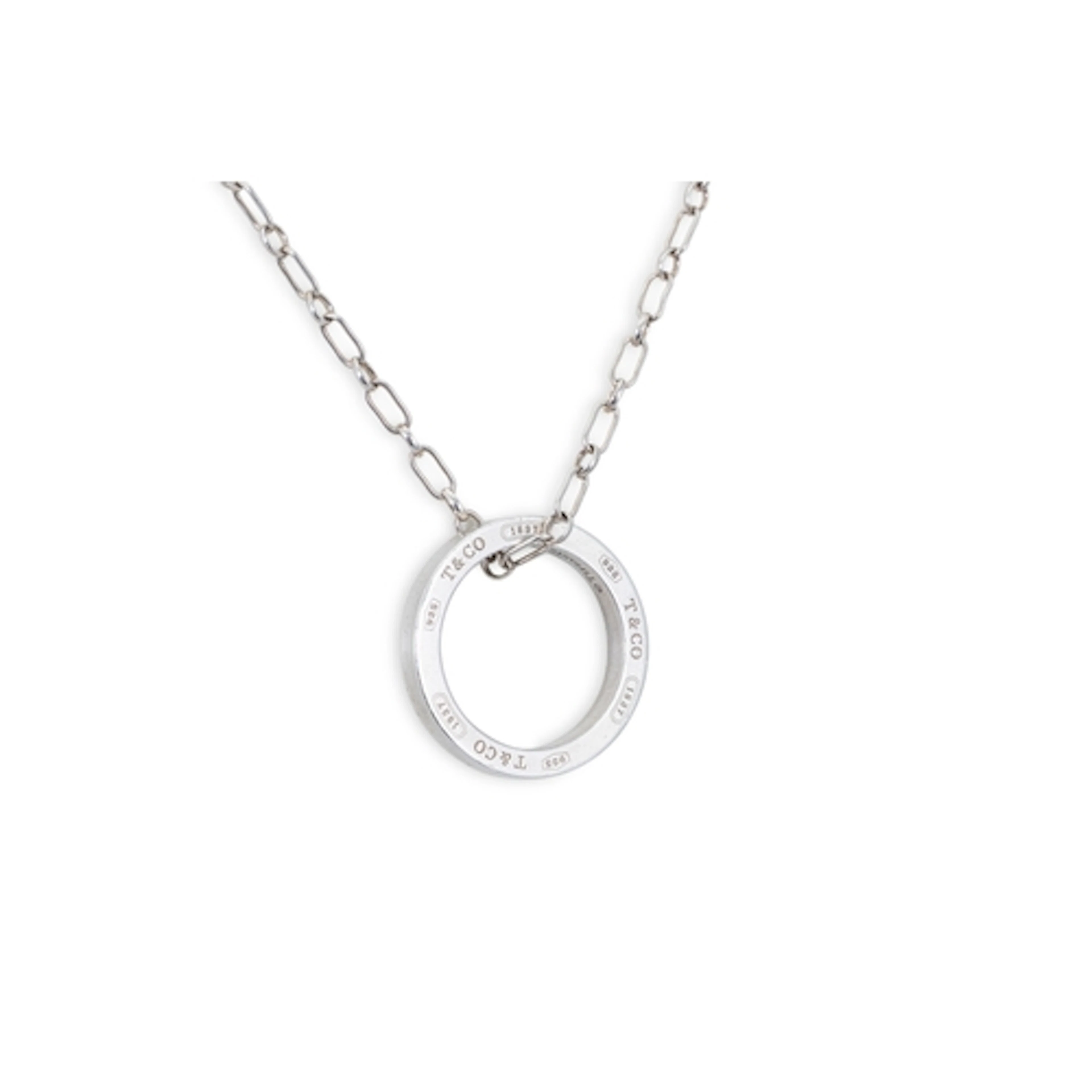 A TIFFANY STERLING SILVER CIRCULAR PENDANT, on a silver chai...