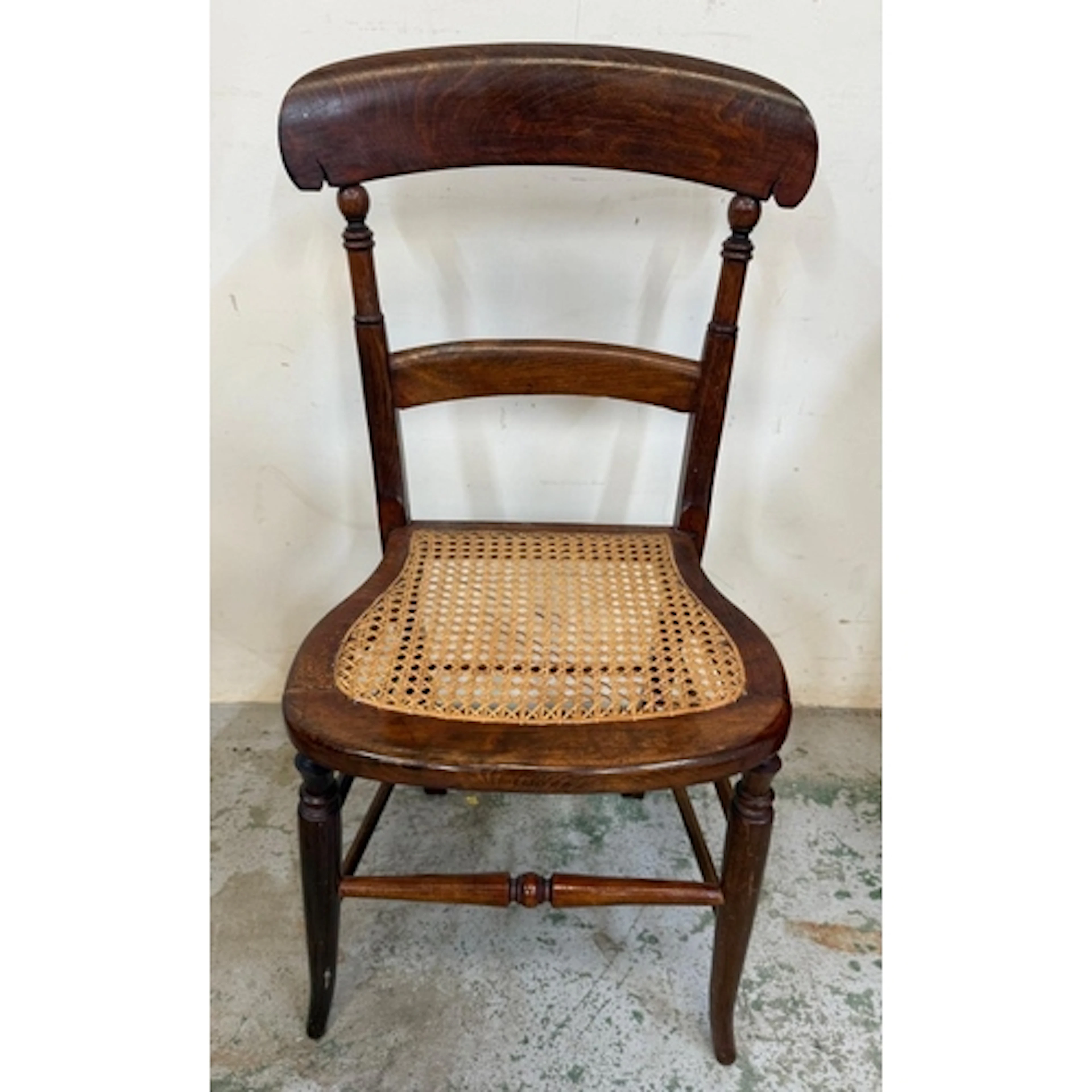 A mahogany cane seated slat backed hall chair