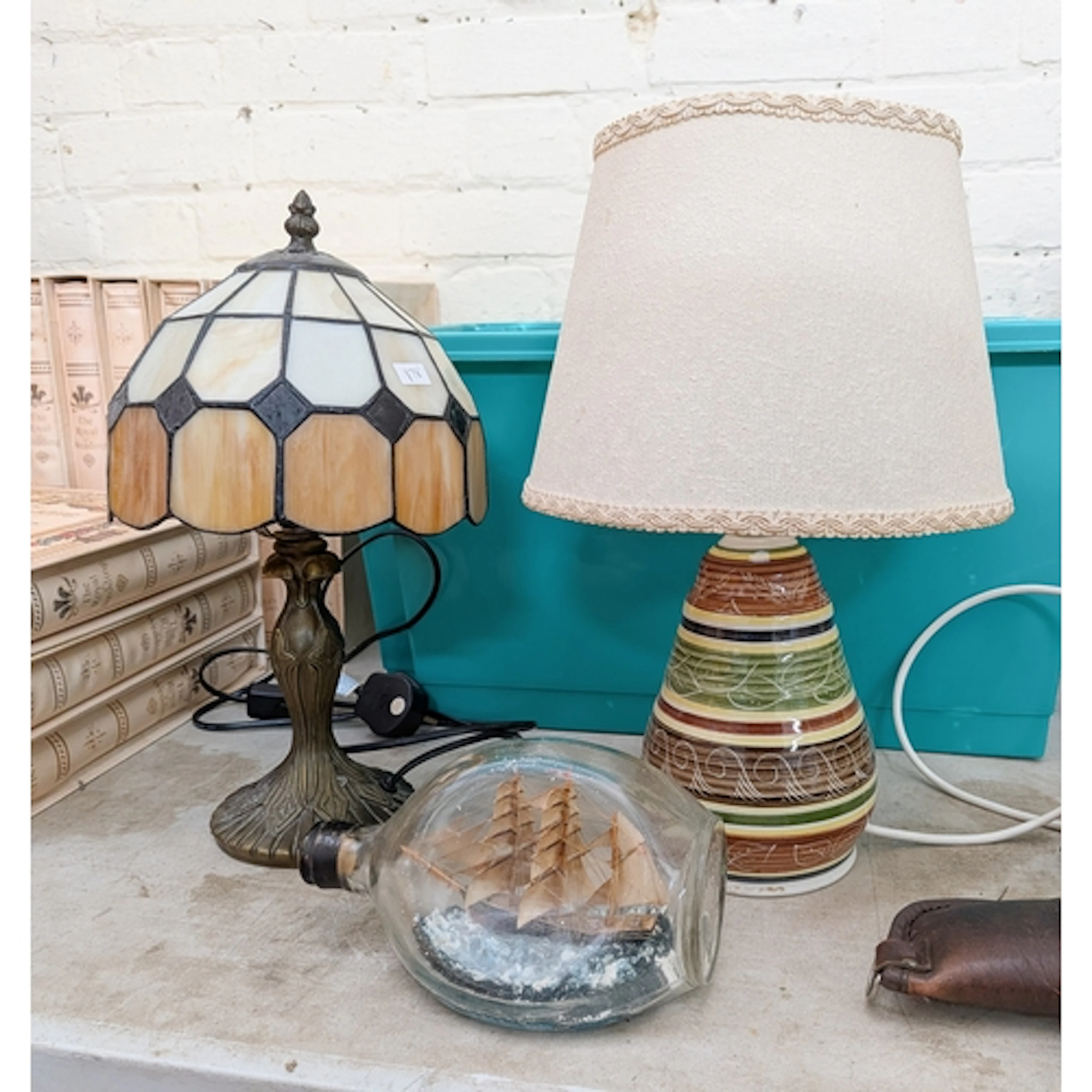 A small Tiffany style table lamp, one other lamp and a ship ...