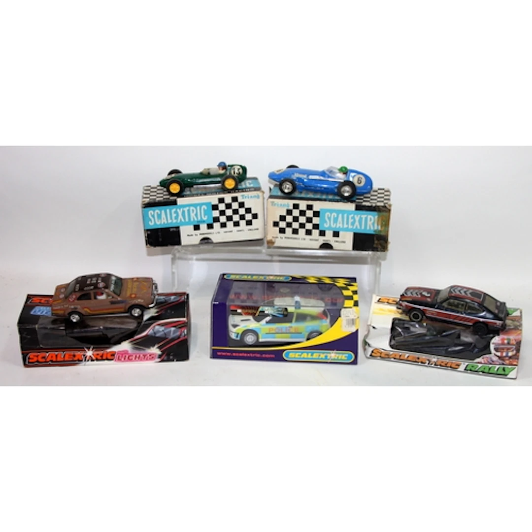 A collection of Scalextric slot car racing vehicles includin...