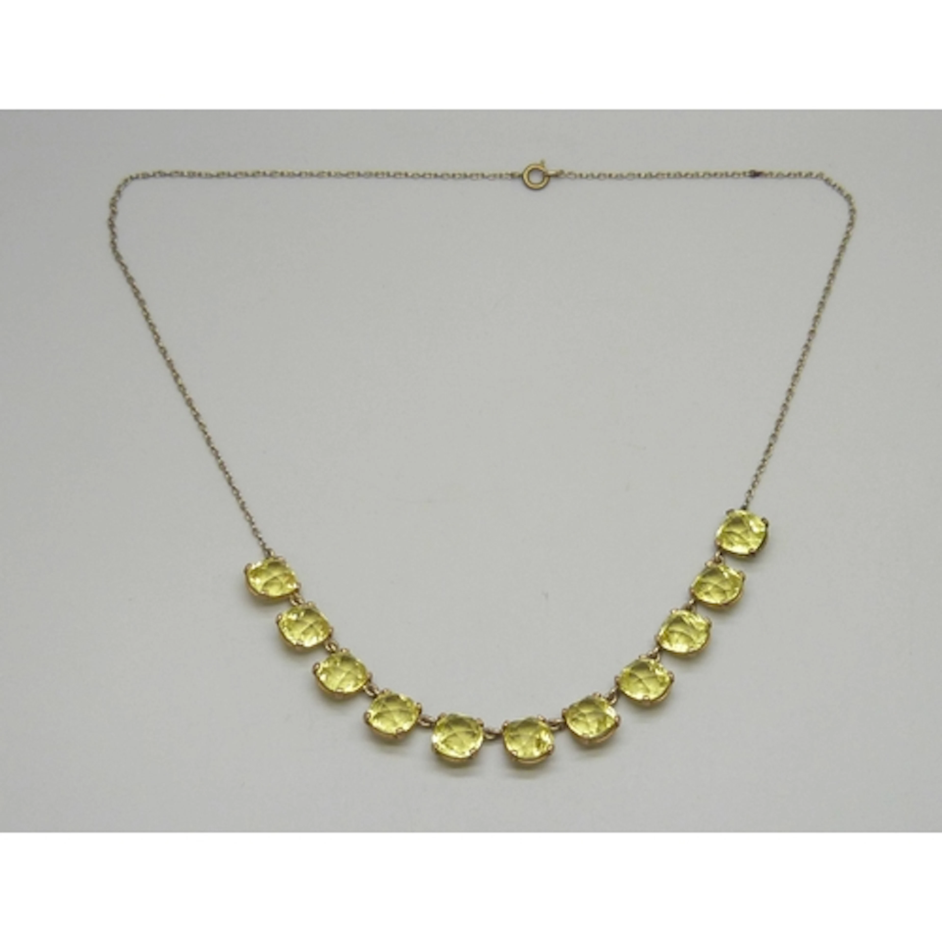 An Art Deco paste yellow stone half riviere gilt necklace, 5...