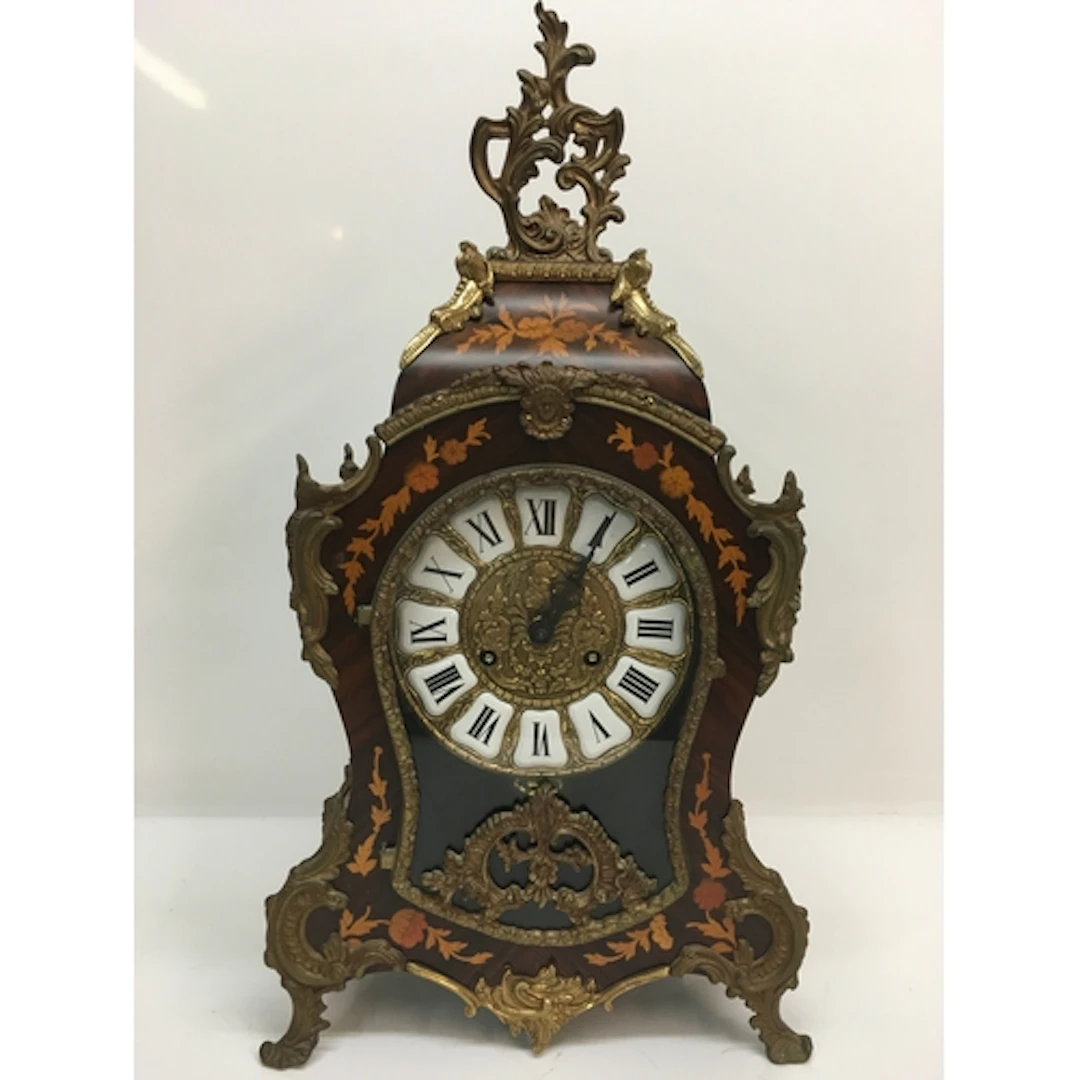 A reproduction French mantle clock of waisted shape, having ...
