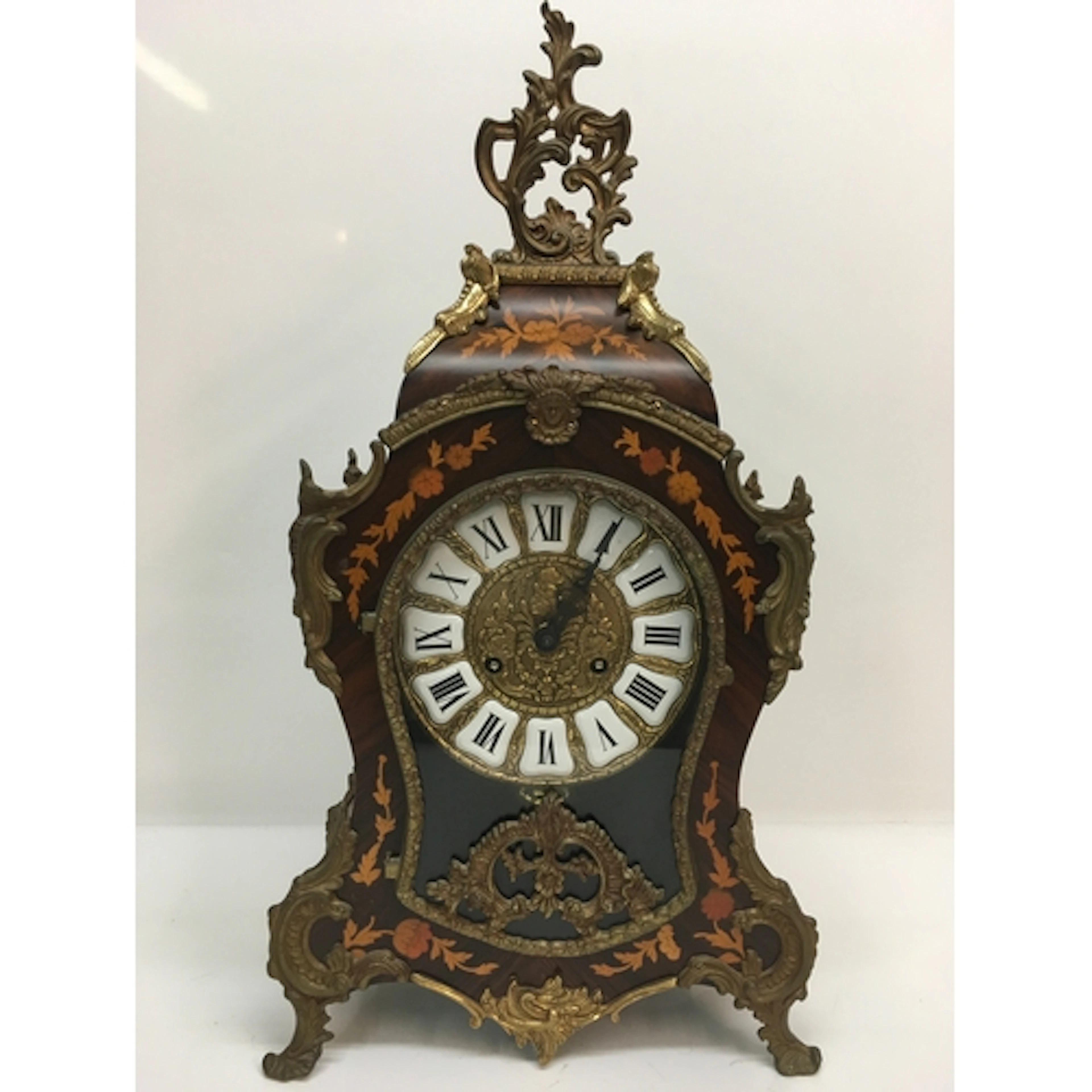 A reproduction French mantle clock of waisted shape, having ...