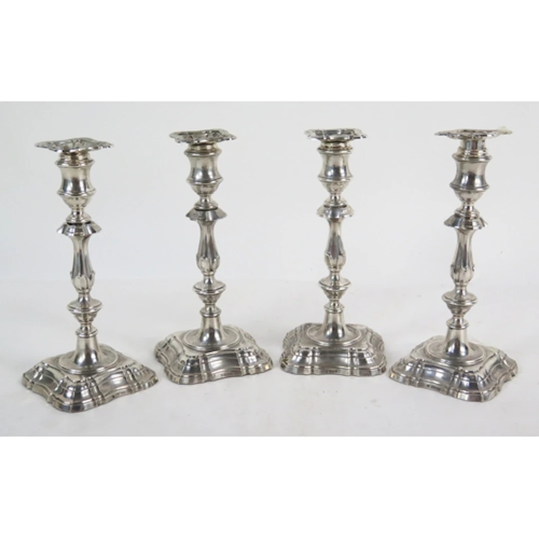 A set of four Edward VII silver candlesticks in the Georgian...