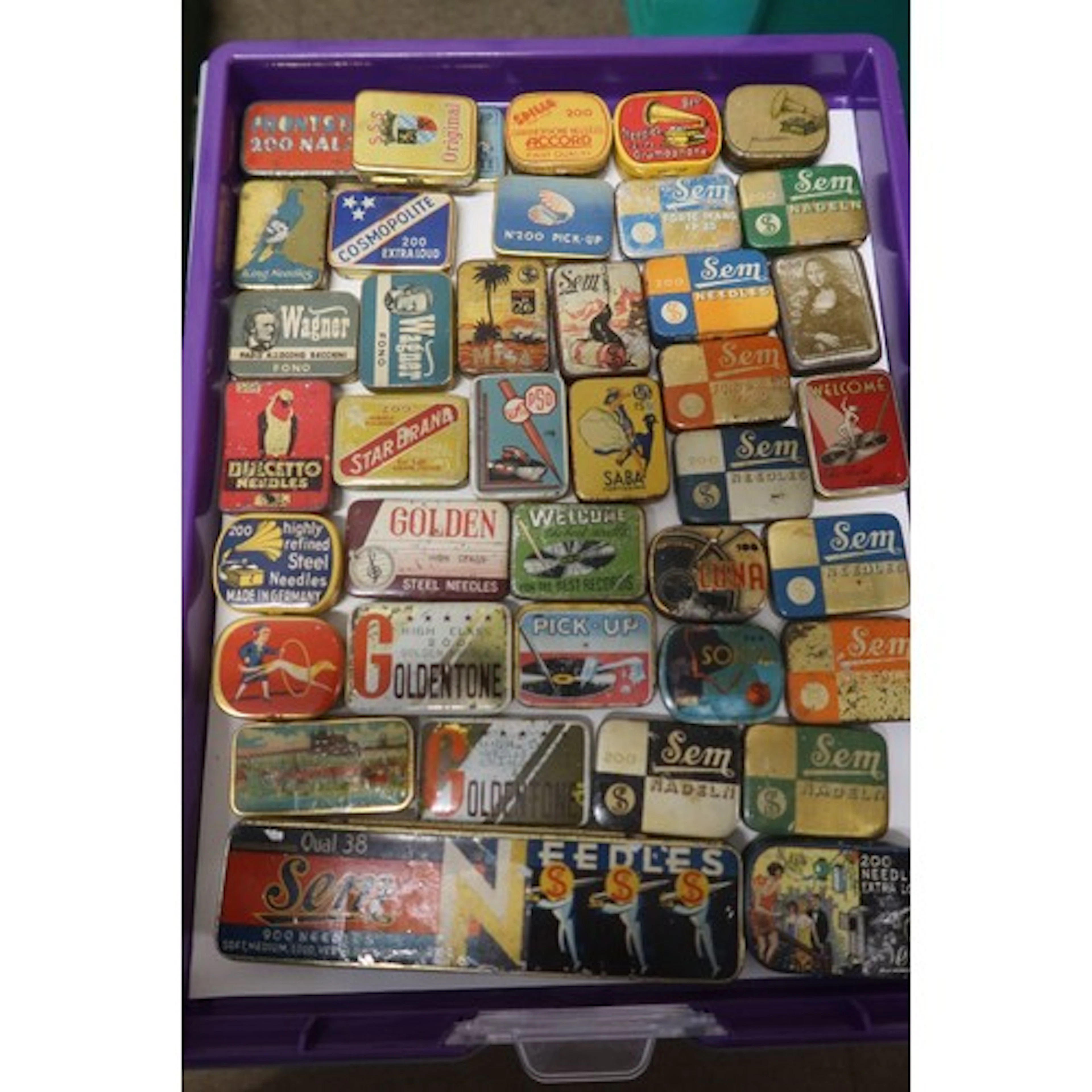 A tray of vintage gramophone needle tins
