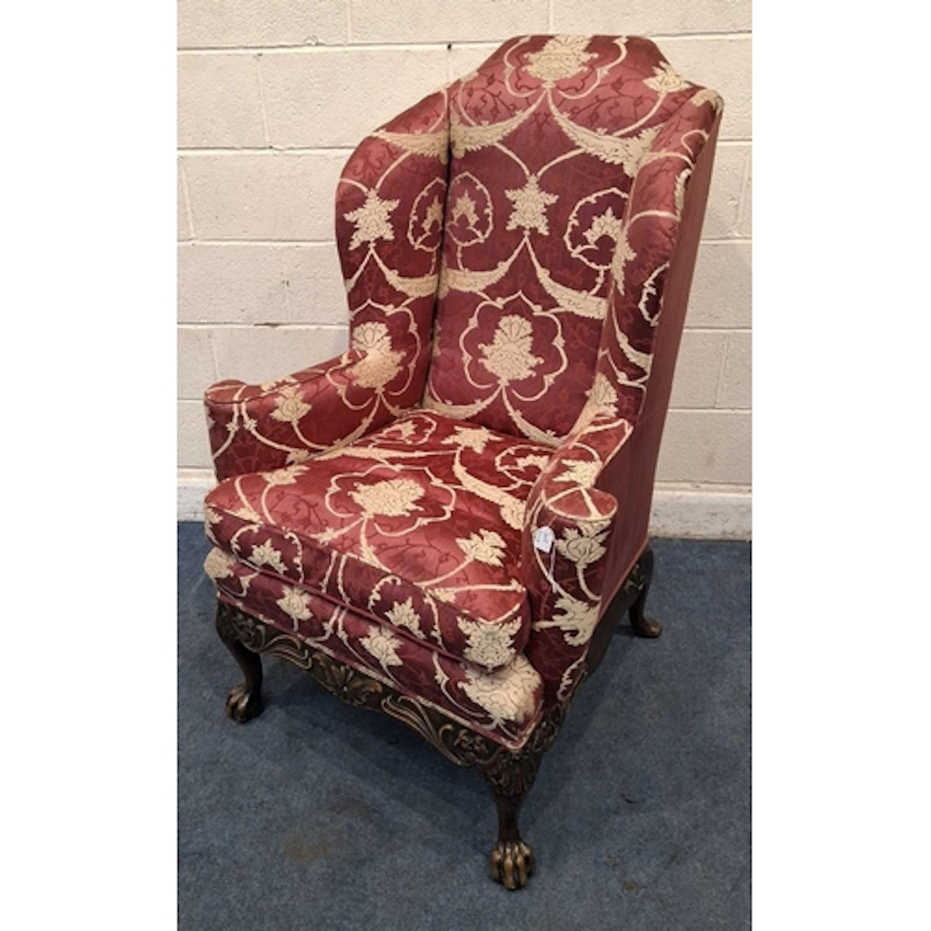 A LATE 19TH / EARLY 20TH CENTURY WINGBACK ARMCHAIR, with rub...